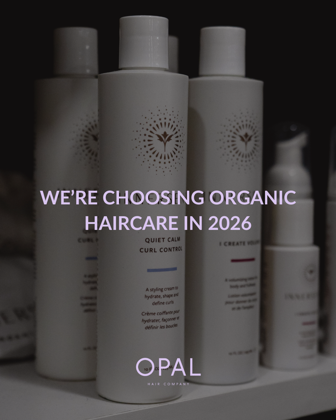 A display of white haircare bottles with minimalist labels and a logo, with text overlay stating 'We're choosing organic haircare in 2026' and the brand name OPAL Hair Company.