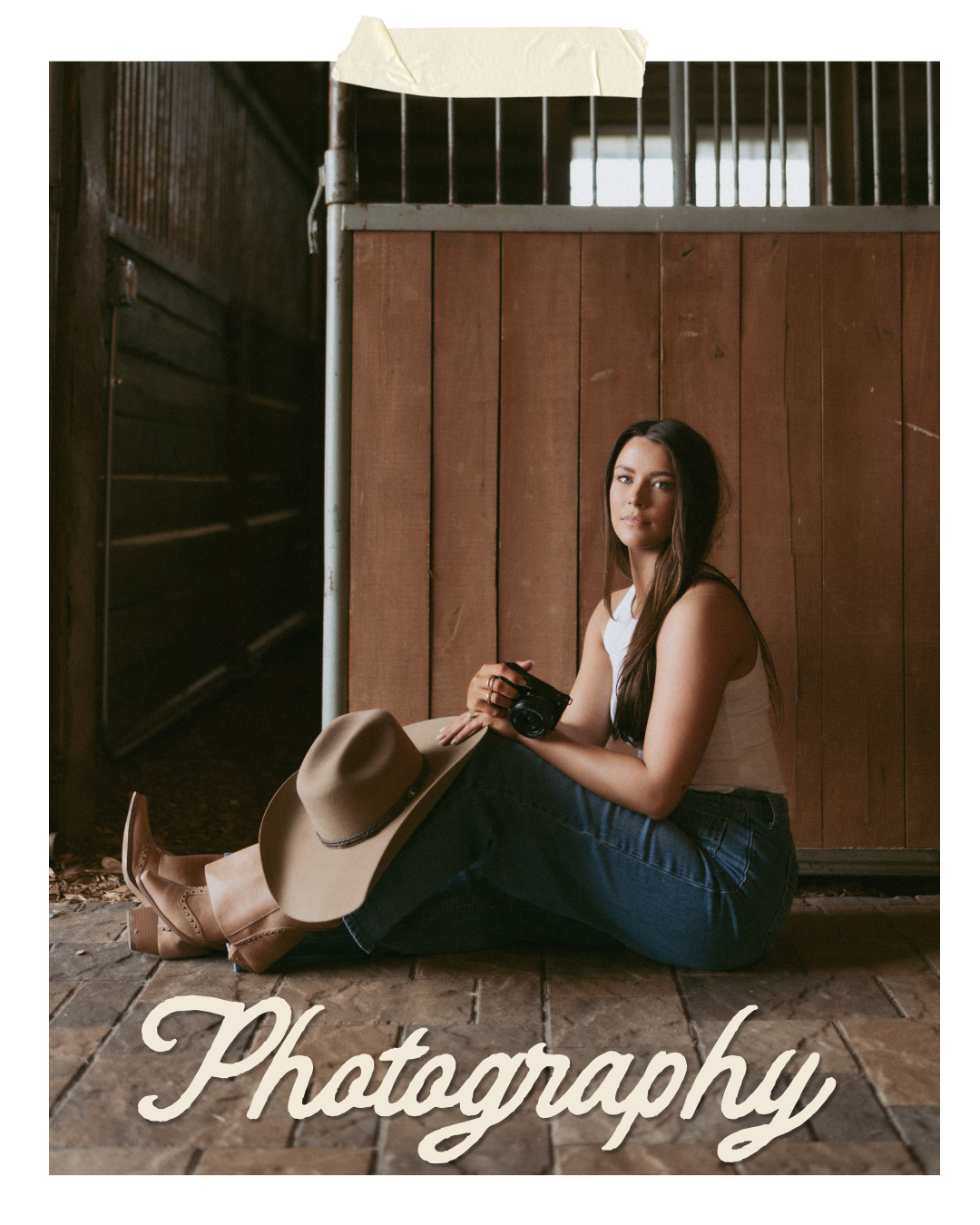 A young woman sitting on a rustic wooden floor, holding a camera and a beige wide-brim hat, with a wooden wall and metal gate behind her, and the word 'Photography' written at the bottom.