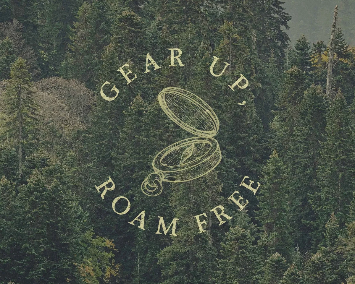 A logo reading 'Gear Up, Roam Free' with an illustration of a compass, over a background of a dense forest.