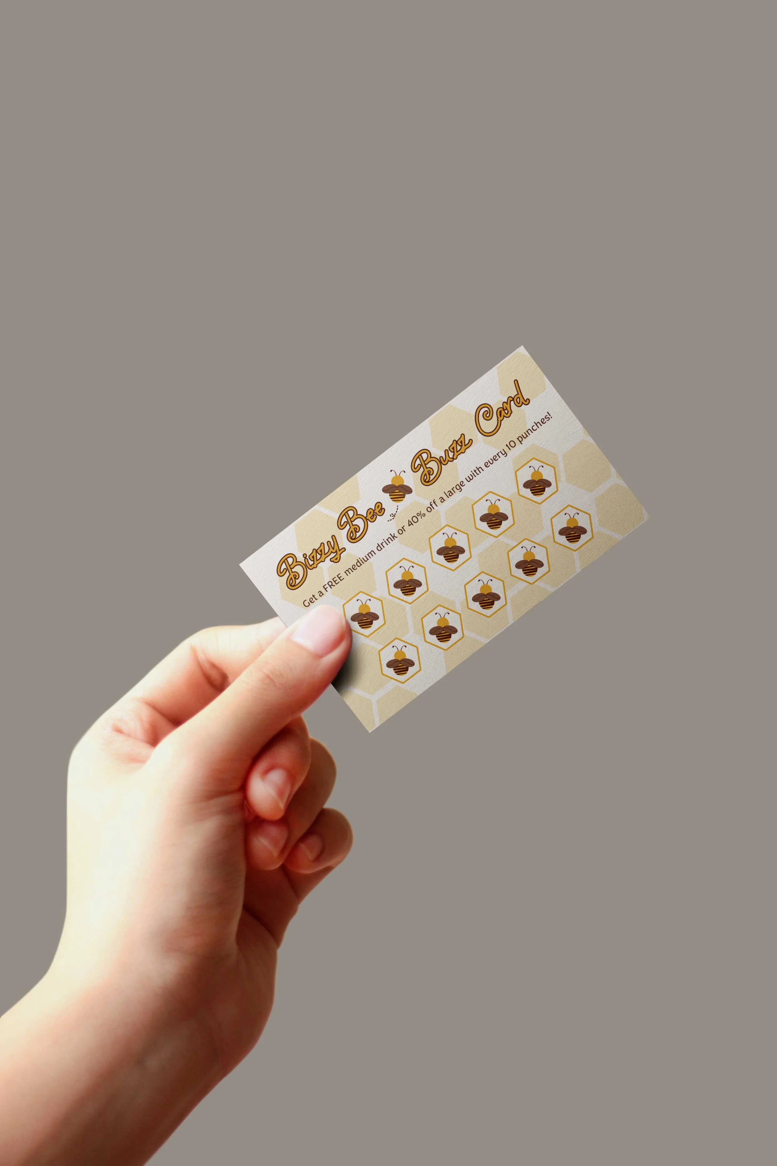 A hand holding a honeybee-themed punch card for a business called 'Buzzy Bee Buzz Card,' with hexagon patterns and small bee icons.