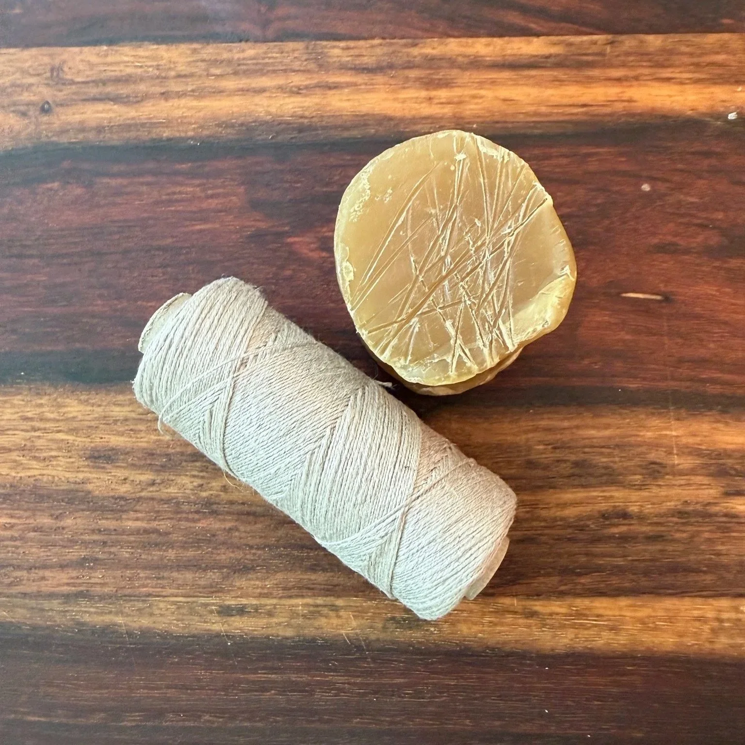 Unwaxed linen thread and beeswax used to hand-stitch Landmade Co. leather goods