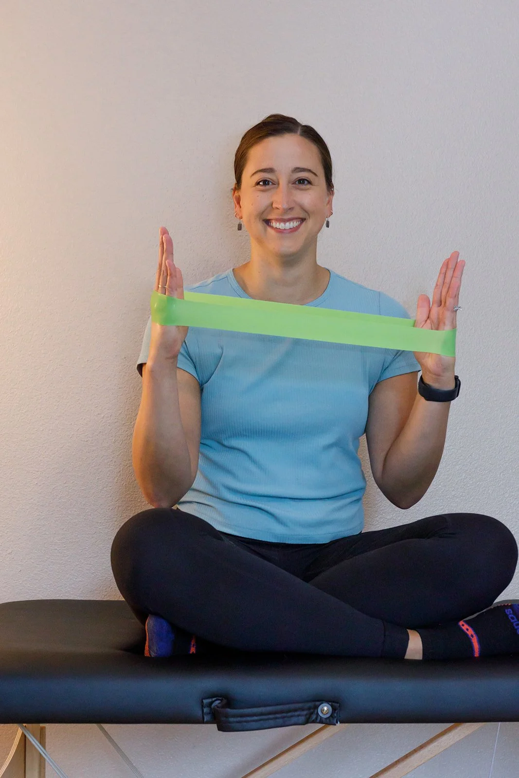 physical therapist and wellness coach sam fox in alaska  posting with therapy band for traning injury or pain