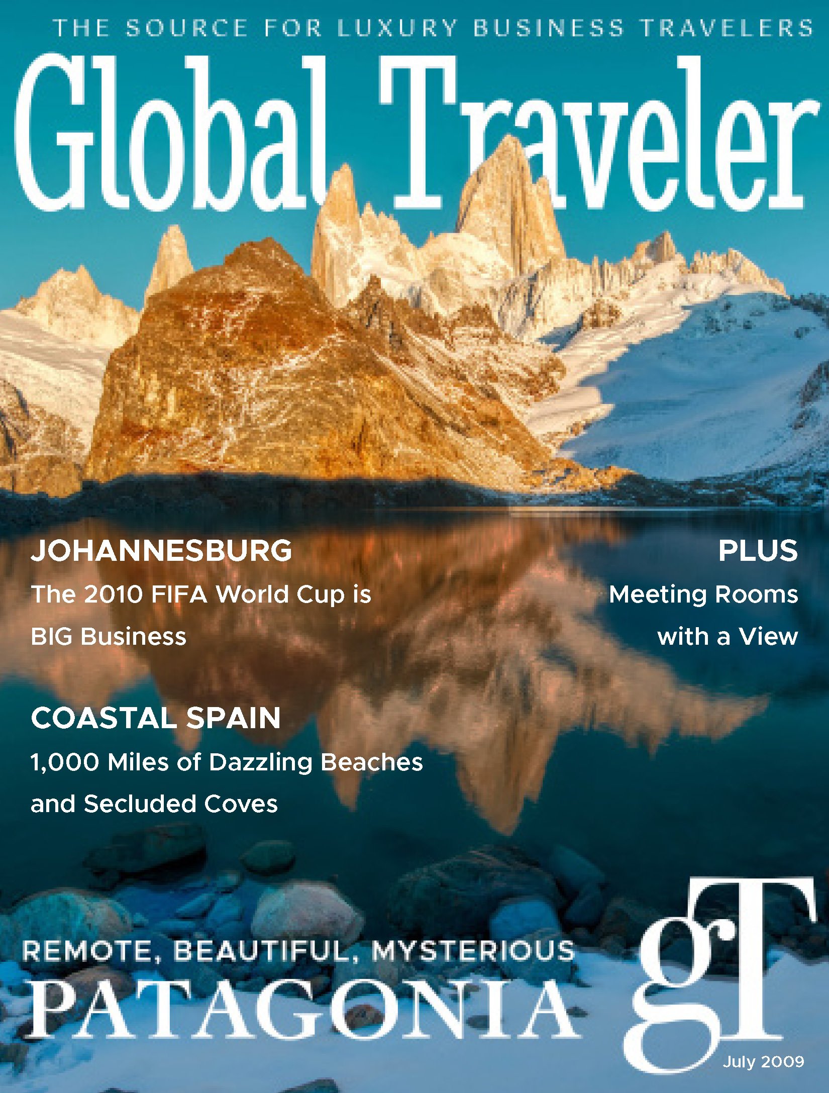 Cover of a travel magazine featuring a mountainous landscape with snow-capped peaks and a lake reflecting the mountains. The text highlights luxury travel destinations including Johannesburg, Coastal Spain, and Patagonia, with details about the 2010 FIFA World Cup, beaches, caves, and scenic views, dated July 2009.