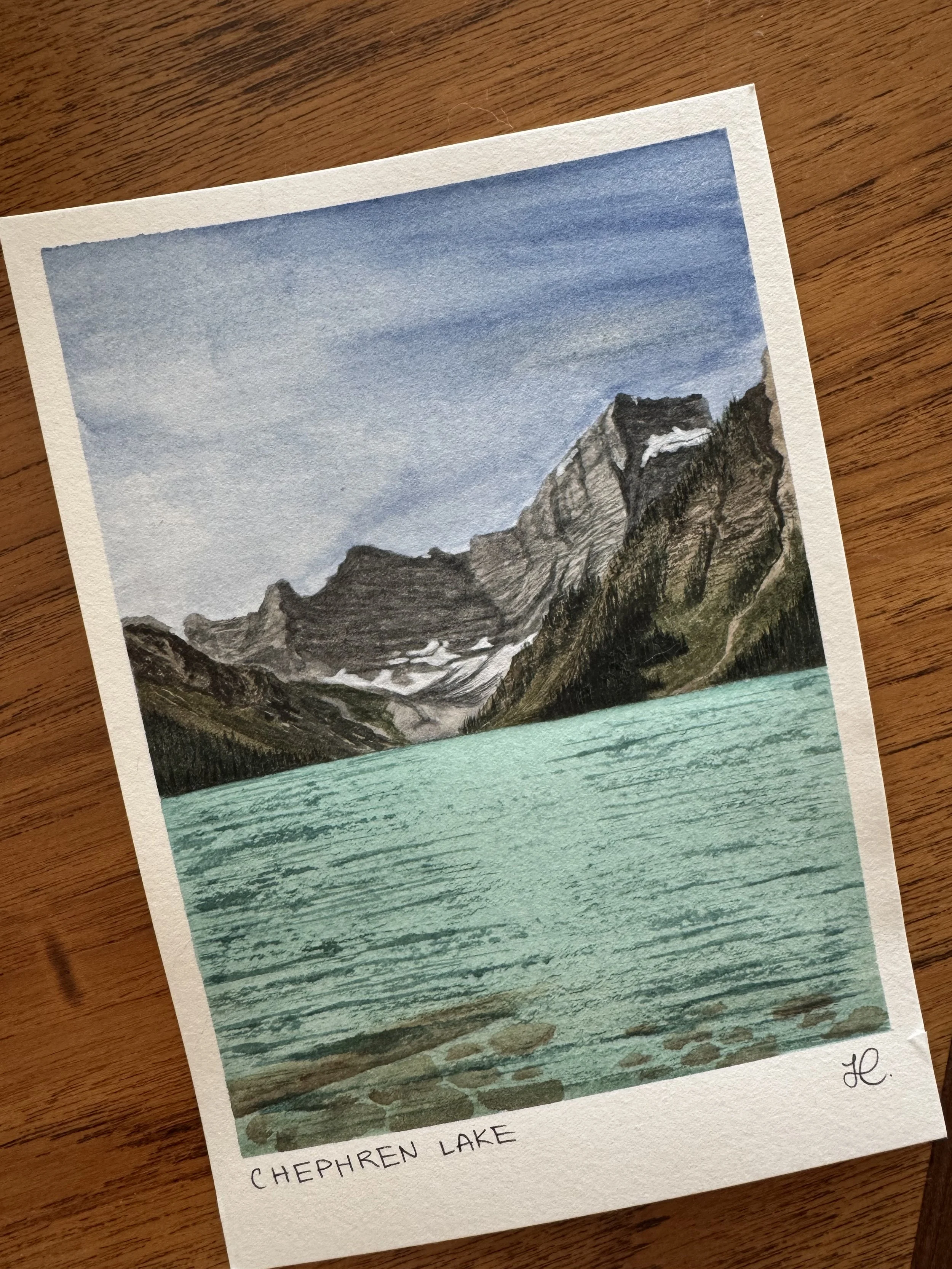 A watercolour painting of a large mountain with a blue lake. Chephren Lake on Icefields Parkway