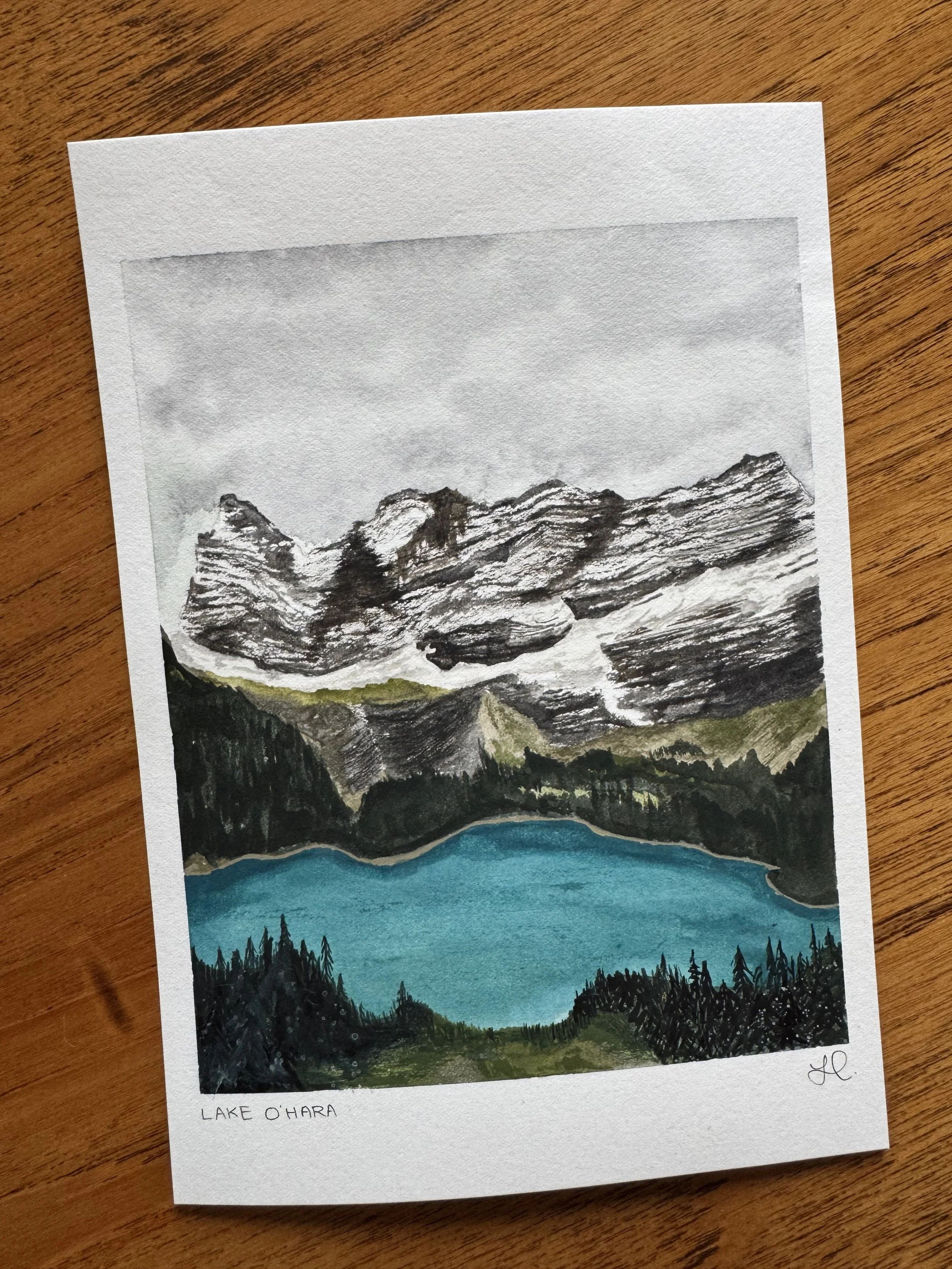 A watercolour original landscape painting of a snowy mountain and blue lake