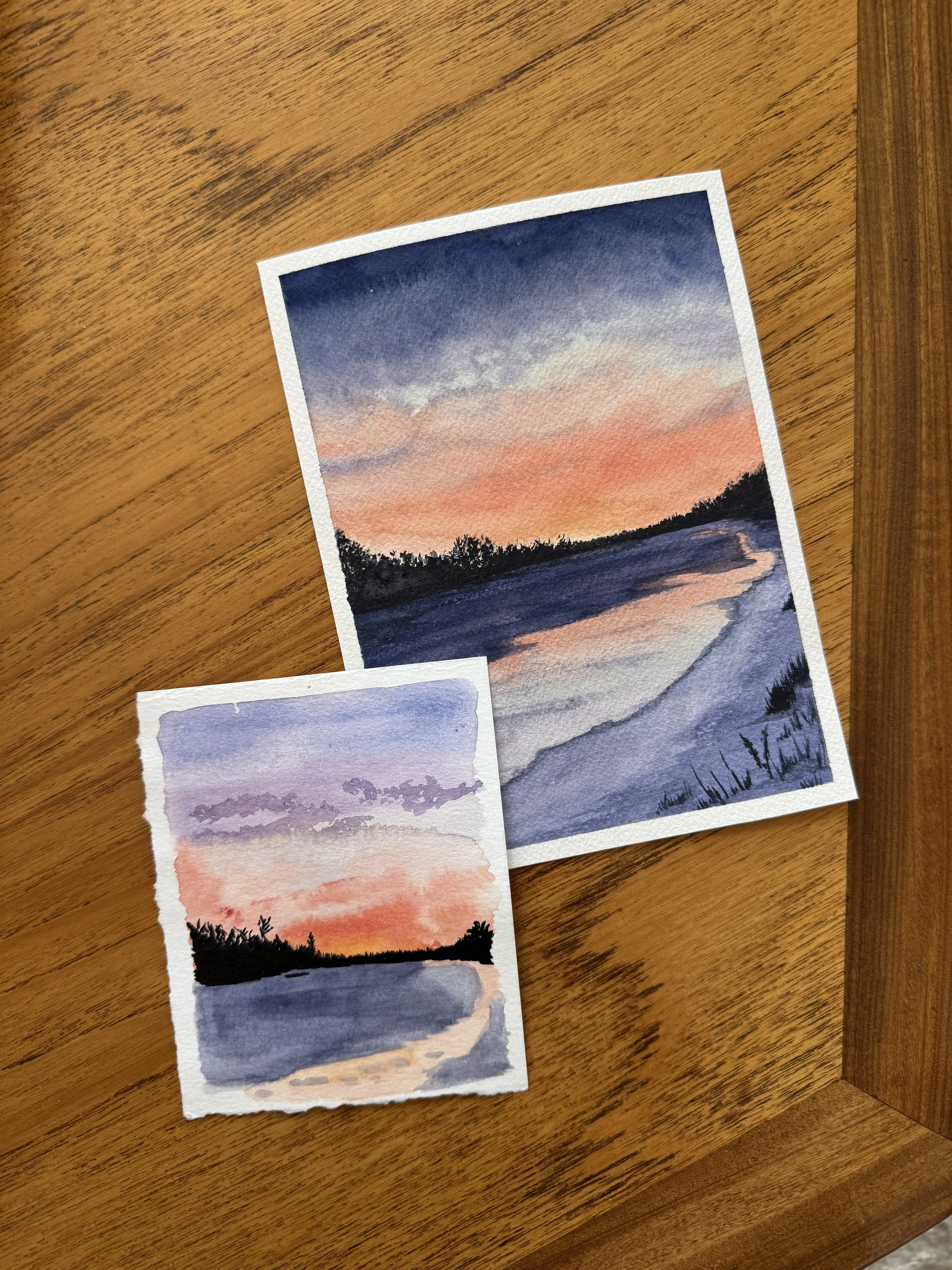 Original watercolour landscape painting of  a purple and orange sunrise on the bow river in Calgary