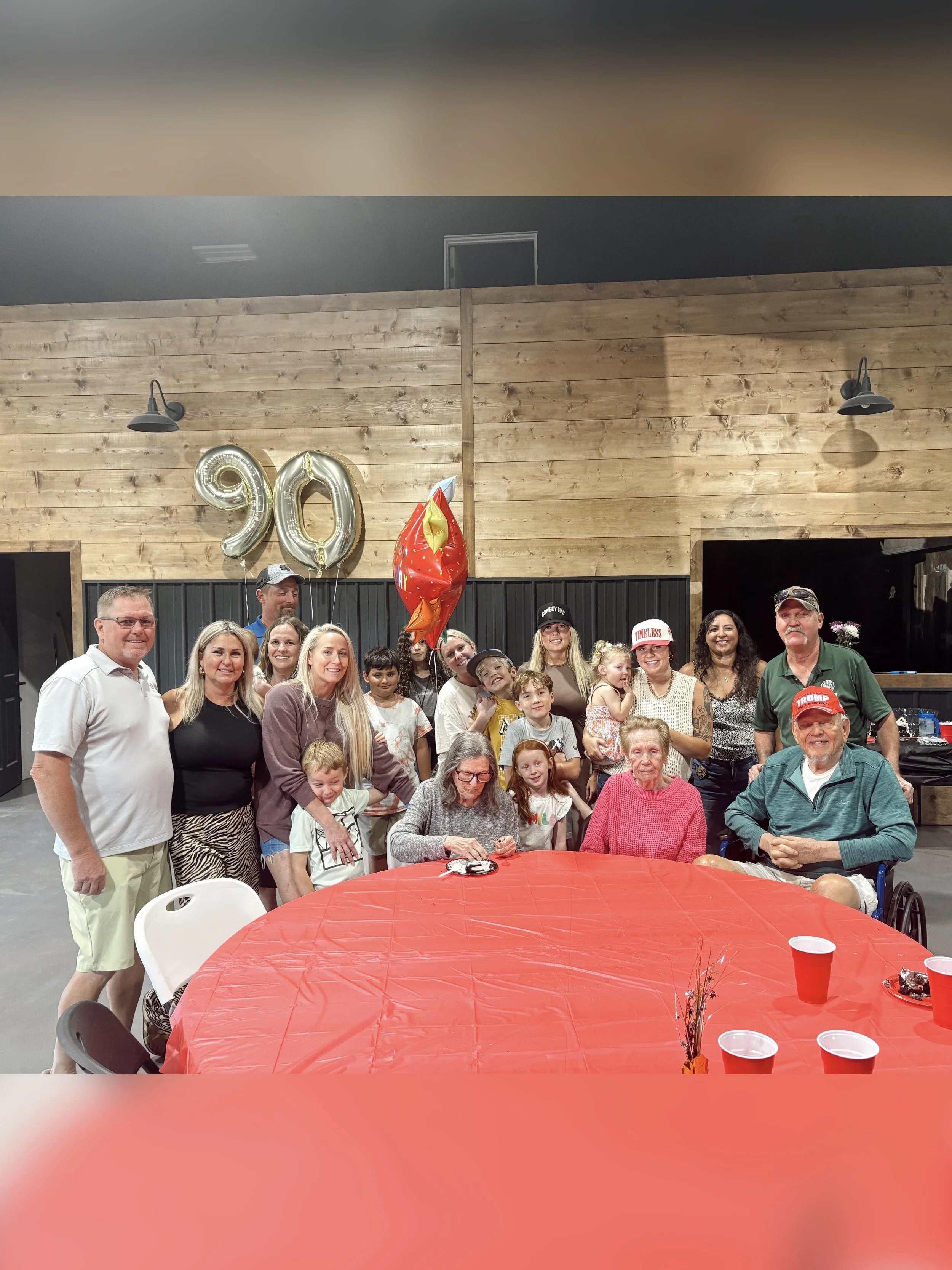 Laurie’s customers, Mariana and Carmen holding hands on a green lawn on their wedding day.