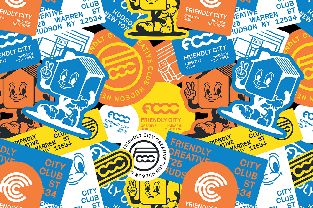A colorful collage of labels, stickers, and cartoon characters promoting the Friendly City Creative Club in Hudson, New York. The design features smiling cartoon house and yellow character graphics with bright colors like blue, yellow, orange, black, and white.