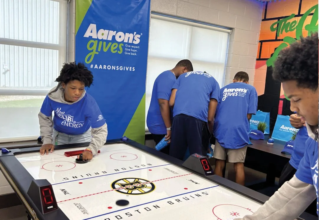 Aaron's Gives charity event with air hockey.