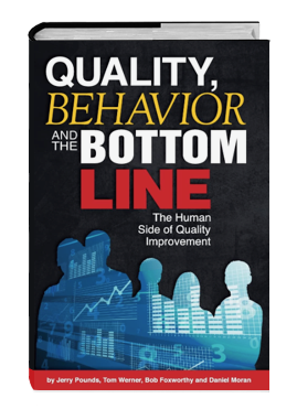 Book titled 'Quality, Behavior and the Bottom Line' by Jerry Pounds, Tom Werner, Bob Foxworthy, and Daniel Moran, featuring a silhouette of four people and a blue graph pattern on the cover.