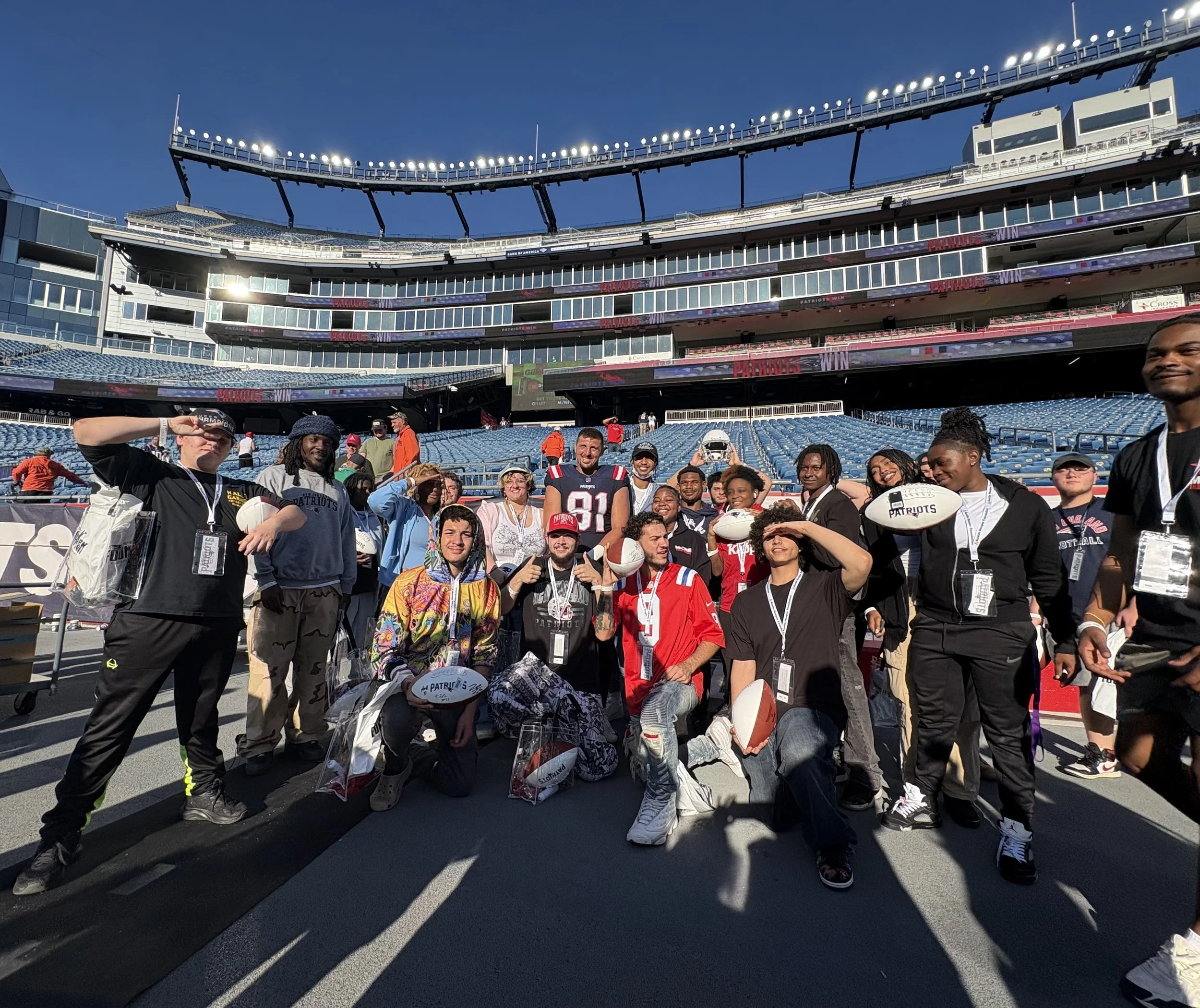 New England Patriot NFL player Austin Hooper with Artem Vale Foundation at patriots game with foster kids aging out of the system. Enjoying a football game at gilette stadium,