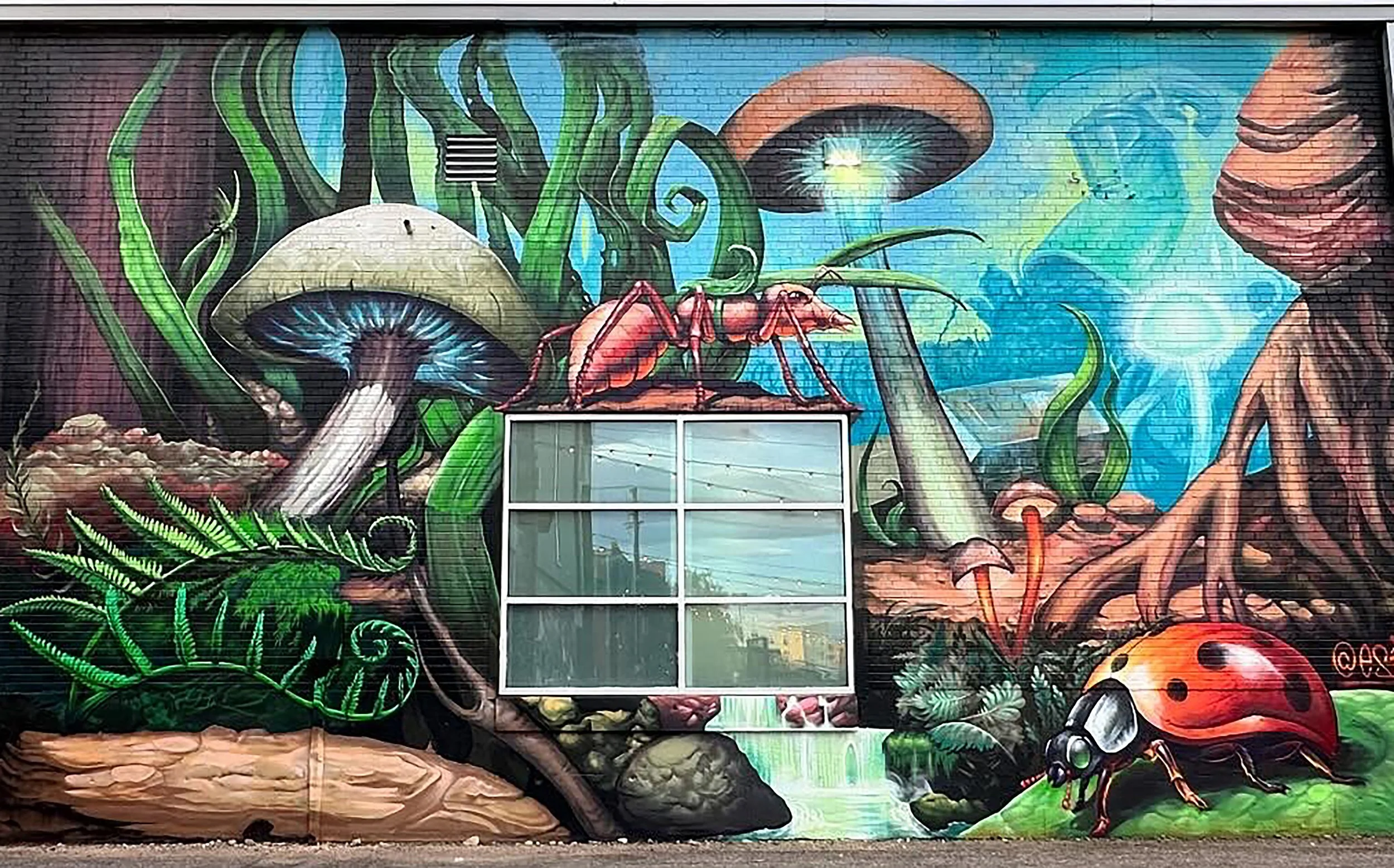 Colorful mural featuring giant mushrooms, insects, and lush plants with a window in the center.