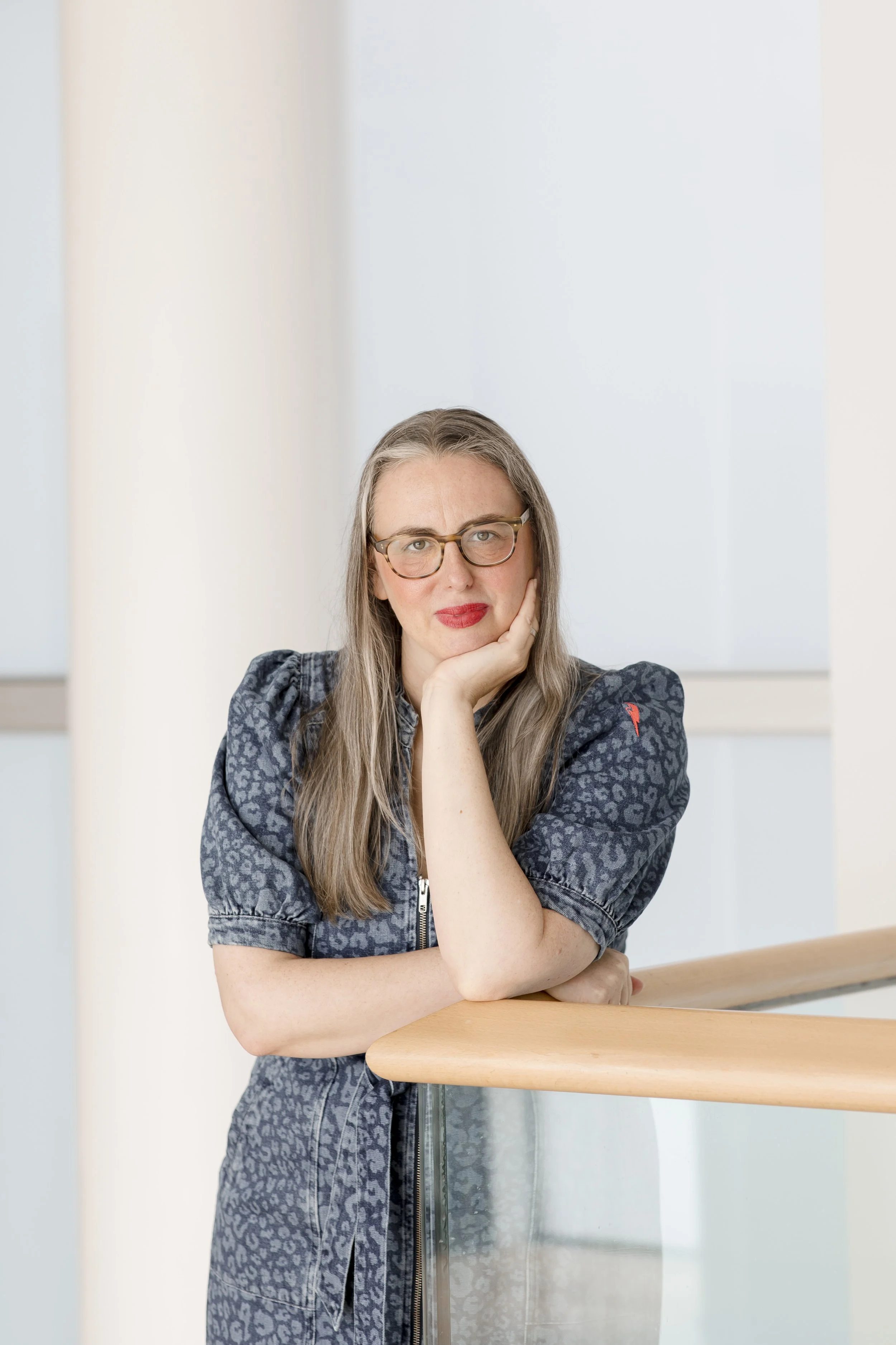 Photo of woman wearing glasses in denim dress