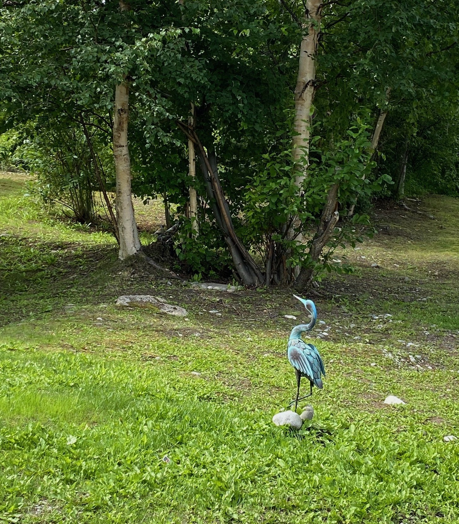 wasilla backyard with crane lawn ornament