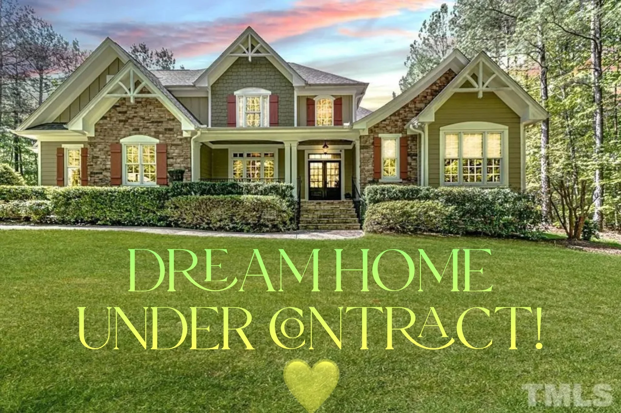 A large, two-story house with a stone and green siding exterior, multiple gables, a front porch with steps, and surrounded by well-maintained bushes and trees. Overlaid on the lawn is text in bright green and yellow reading 'Dream Home Under Contract!' with a small heart below.
