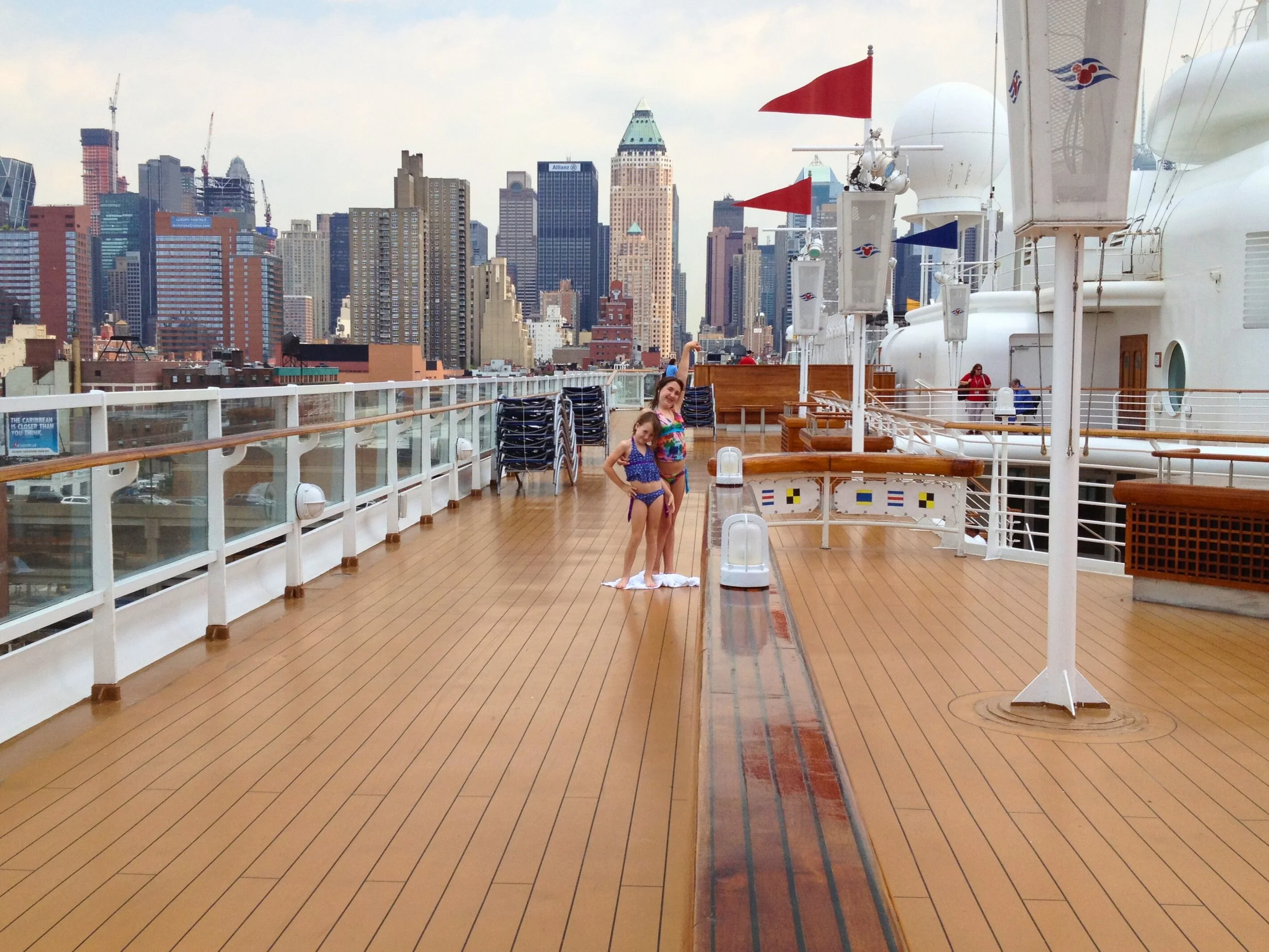 On The Disney Magic, Maggie's two children are on the top deck. The New York city skyline is visible in the background.
