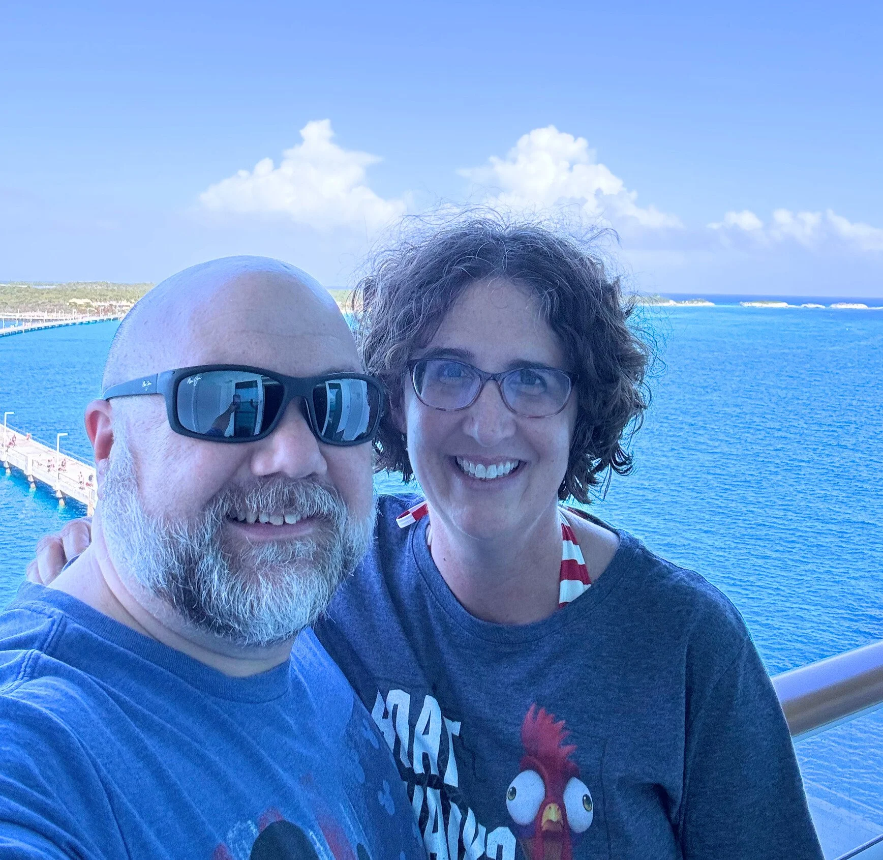 On the Fantasy, Dave and Maggie are relaxed. The beautiful blue ocean is in the background.