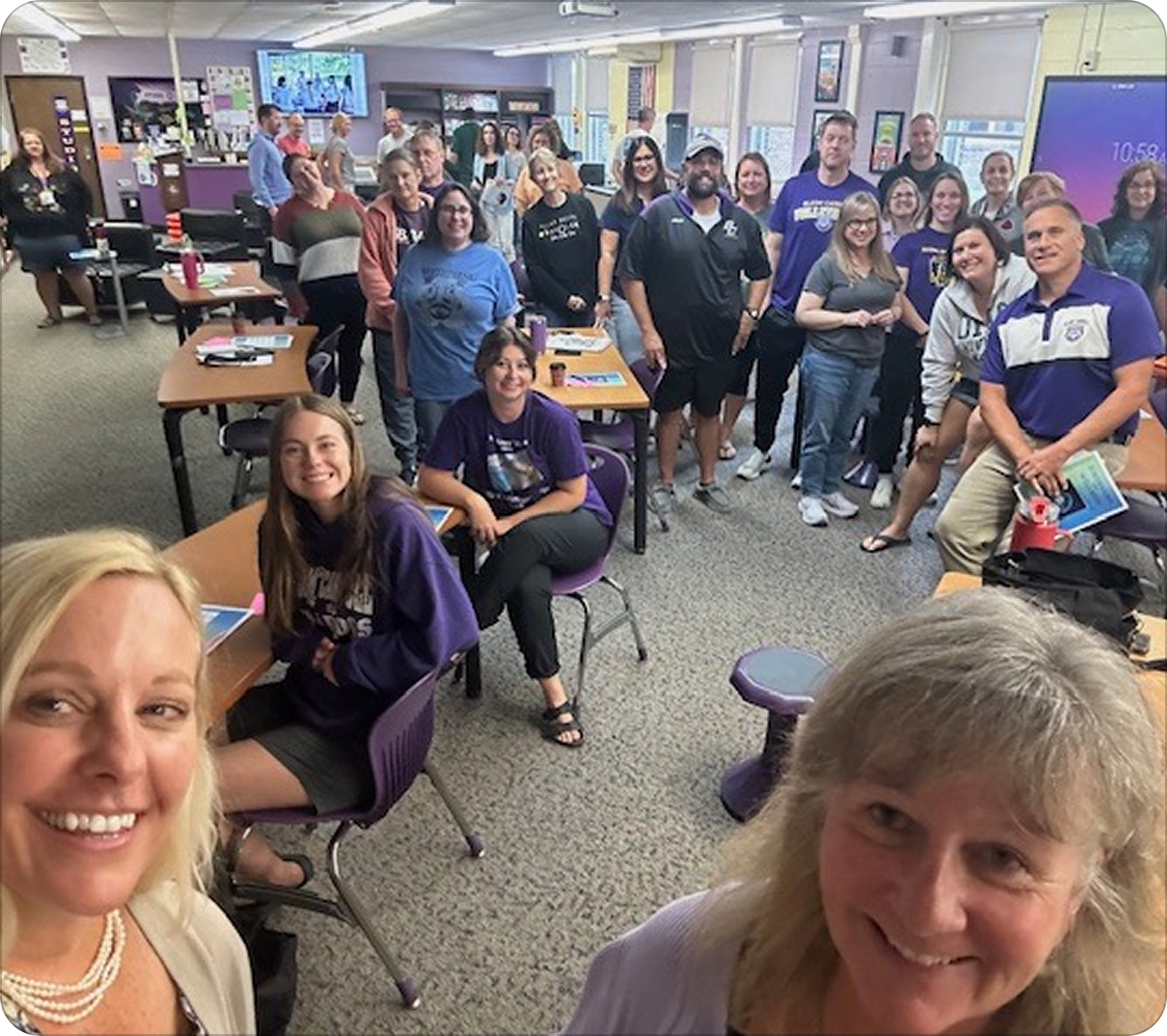 Group of people gathered in a classroom or conference room for a meeting or event.