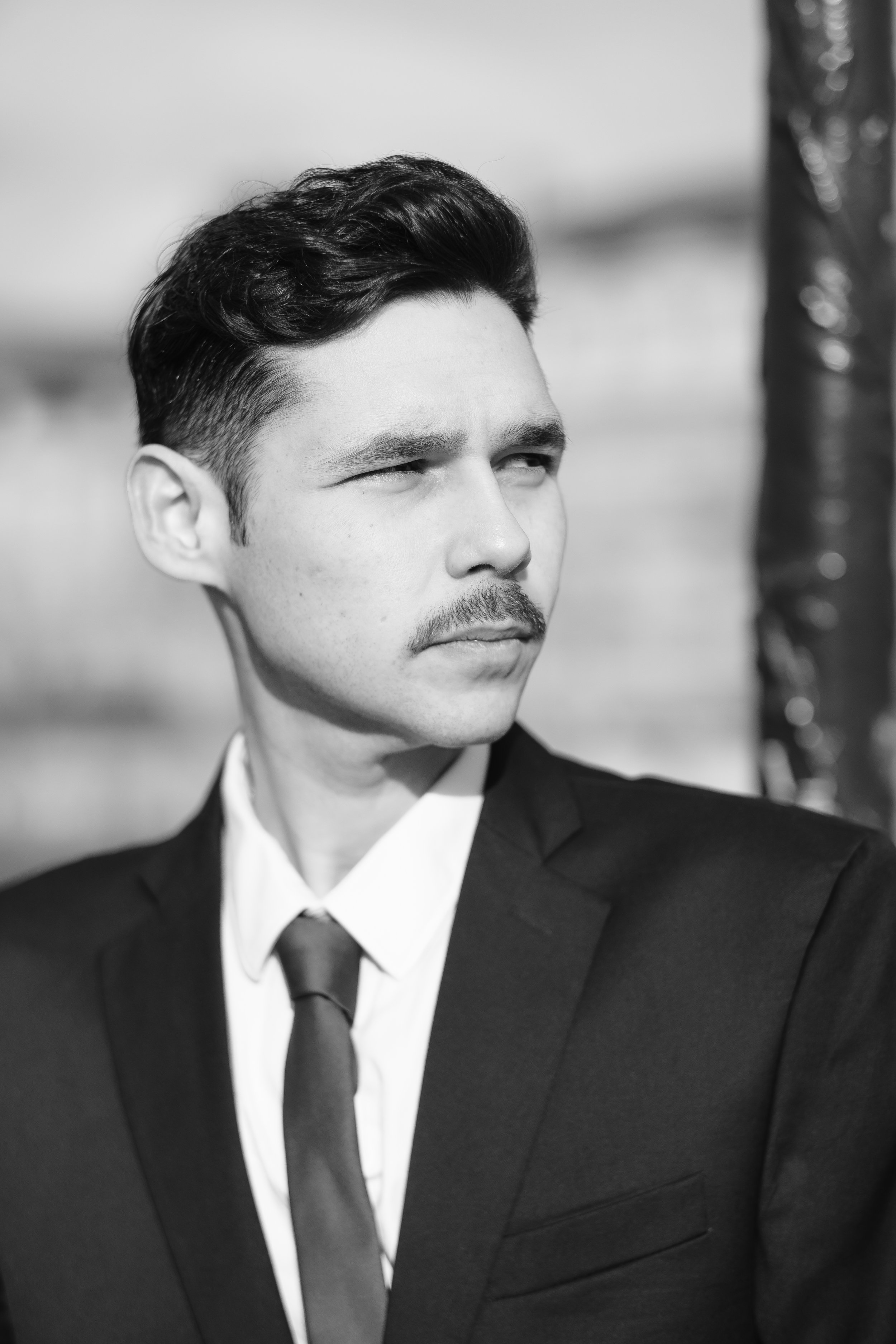 Portrait noir et blanc de Marwan sur le pont des Arts à Paris. 