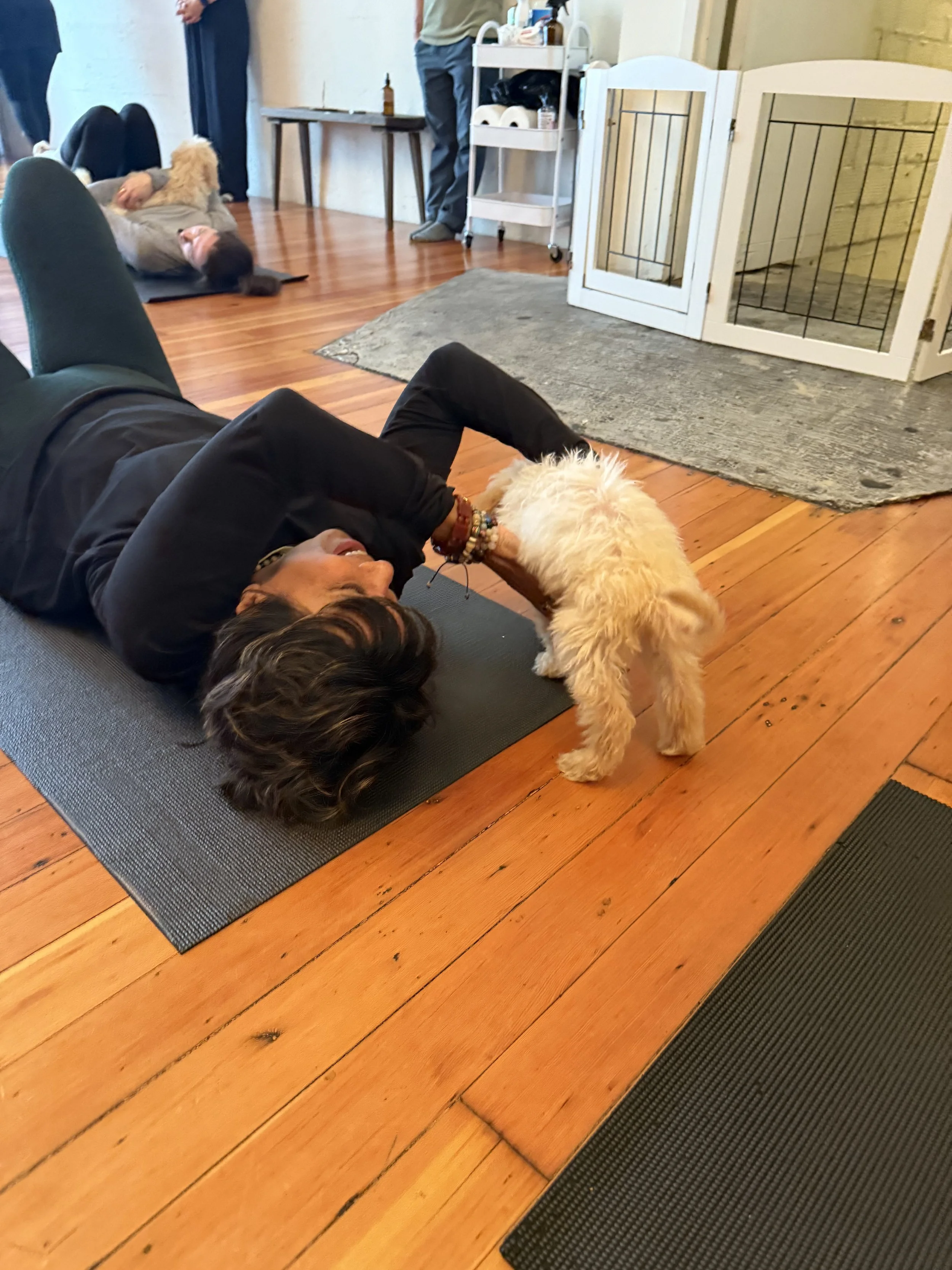 Friends and referrals celebrating at Puppy Yoga 2025 surrounded by puppies in Portland, OR
