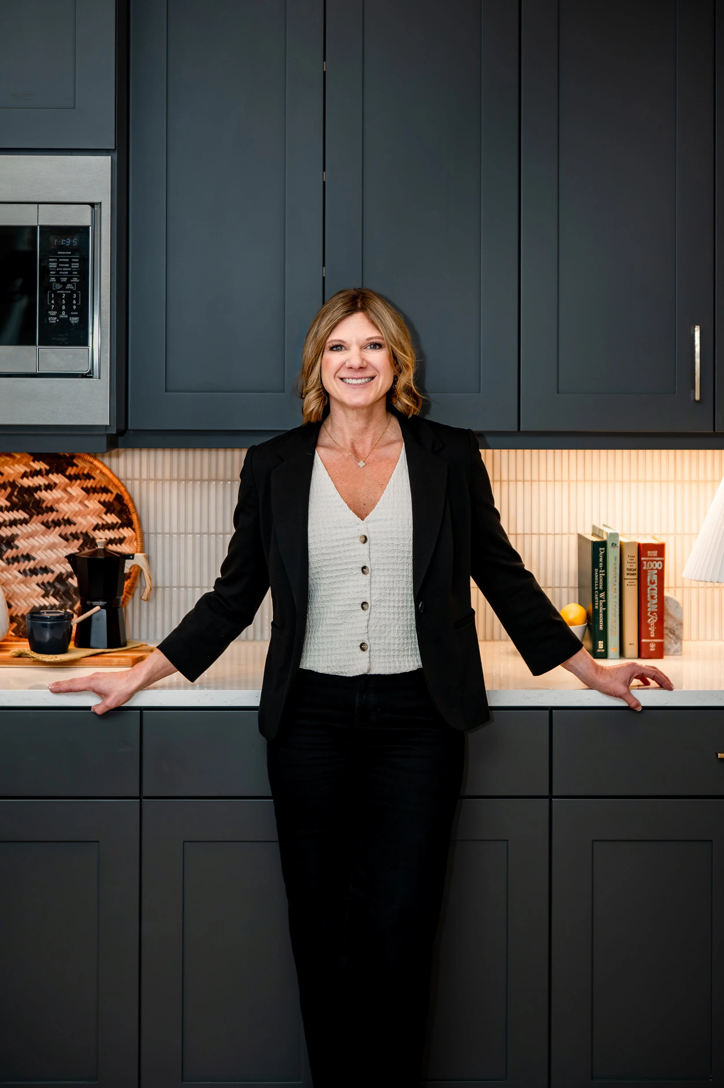 Rhonda Riley standing in a modern kitchen offering real estate relocation guidance in Beaverton Oregon