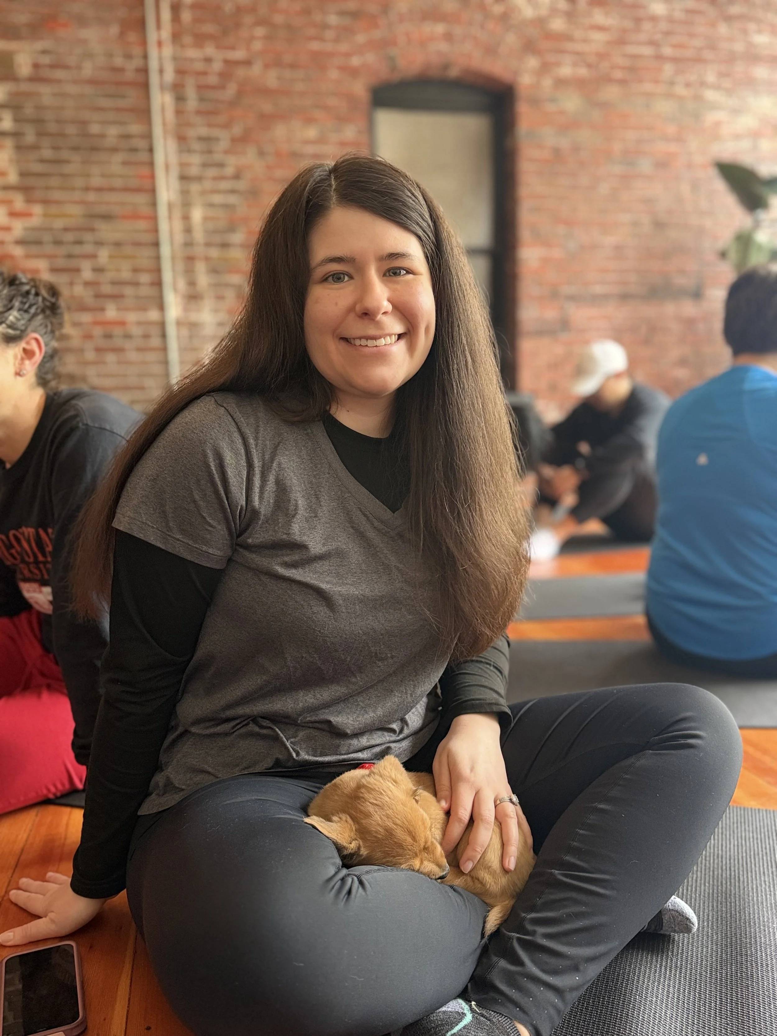 photo of VIP client, surrounded by puppies at Puppy Yoga 2026 in Portland, OR