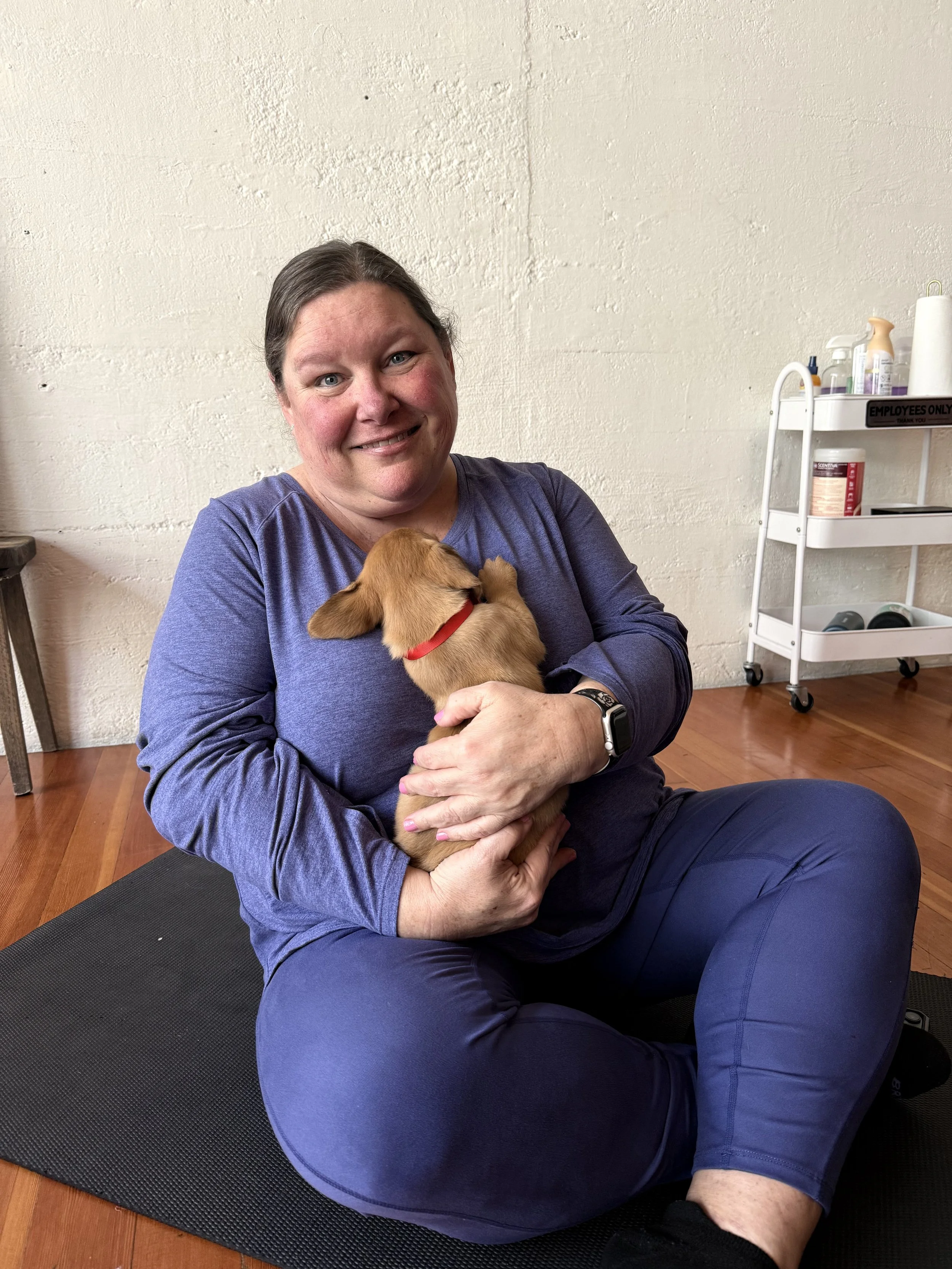happy VIP client stretching and laughing during Puppy Yoga 2026 in Portland, OR