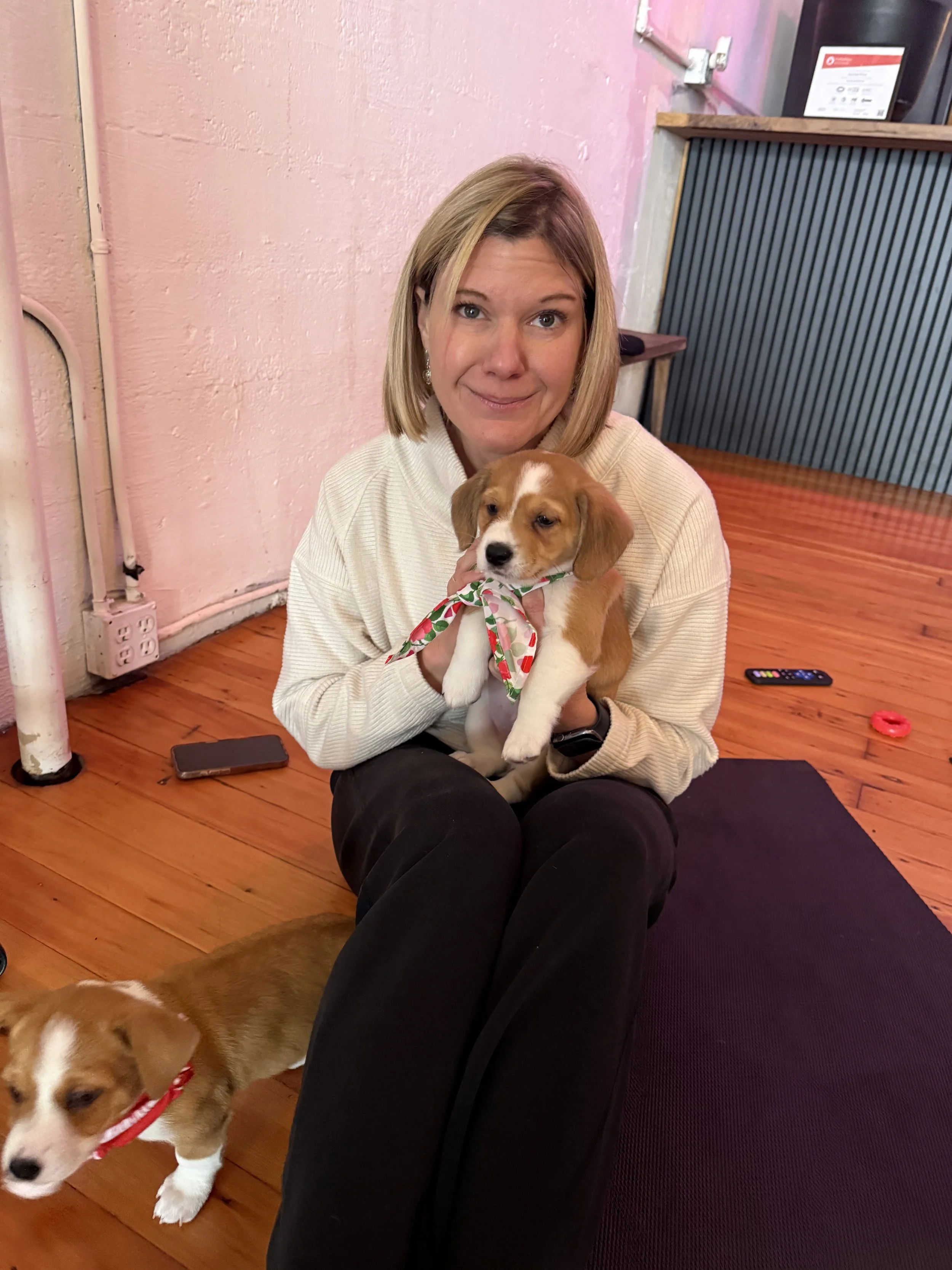 Rhonda playing with puppies during Puppy Yoga 2026 with Rhonda Riley at a VIP event in Portland, OR