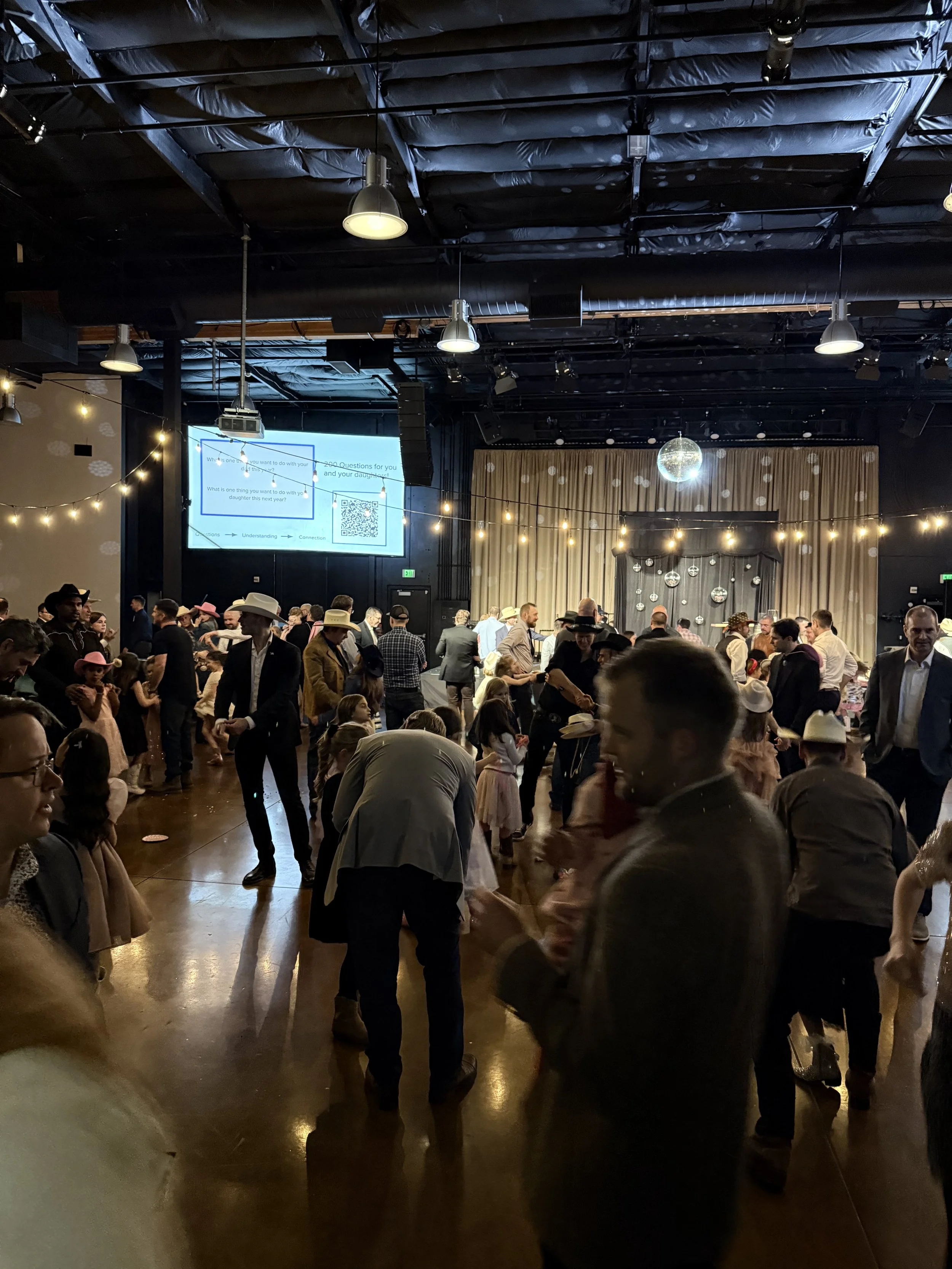 Festive ballroom with fathers and daughters at the Young Life Father Daughter Dance in Portland, OR