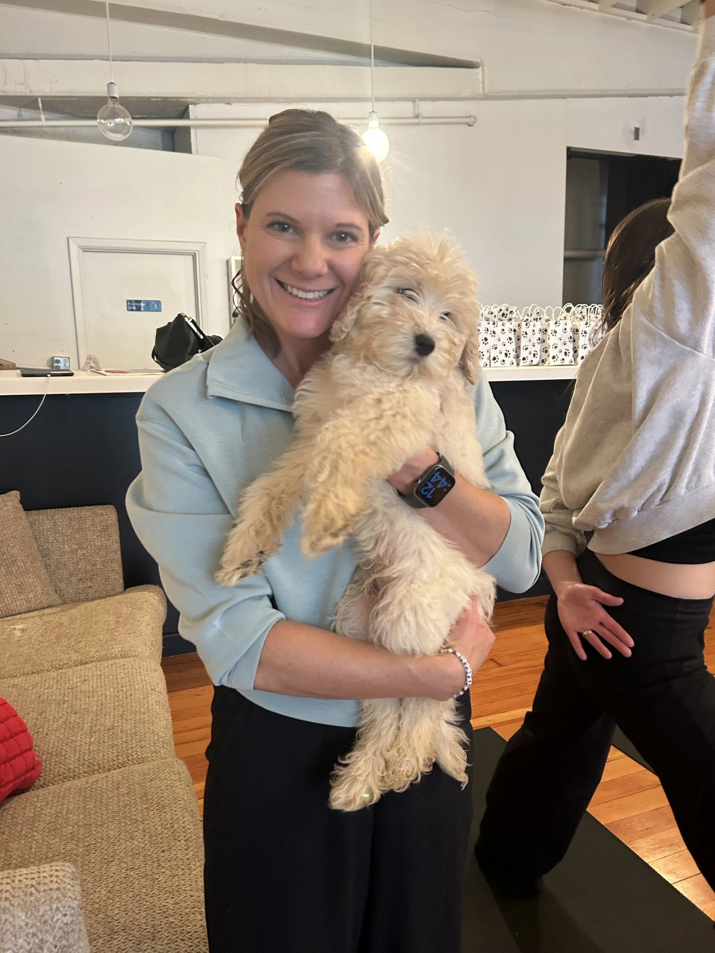 Rhonda Riley smiling and posing at Puppy Yoga 2025 VIP client event in Portland, OR