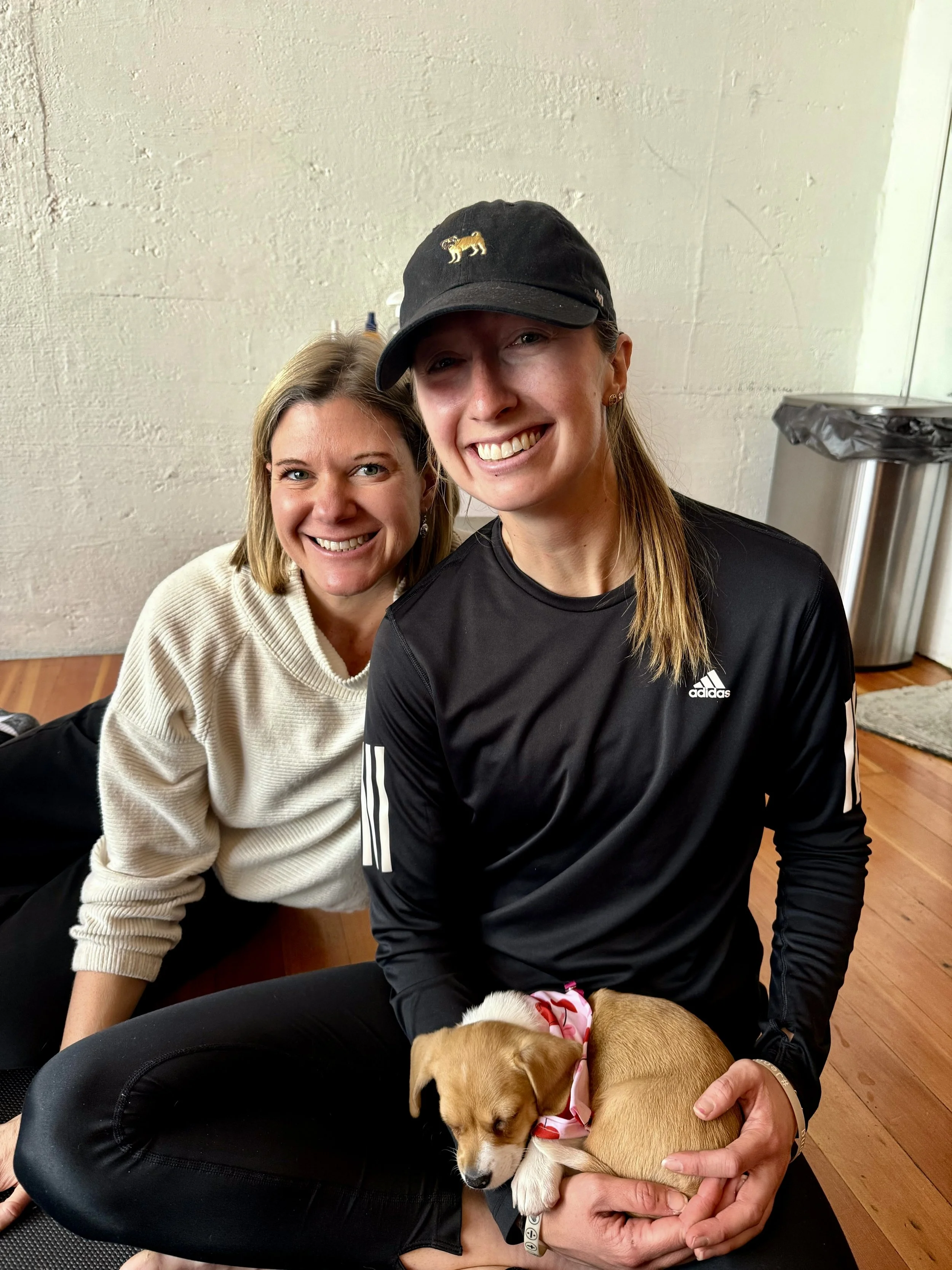 VIP clients and referrals enjoying Puppy Yoga 2026 with puppies, smiling with Rhonda Riley in Portland, OR