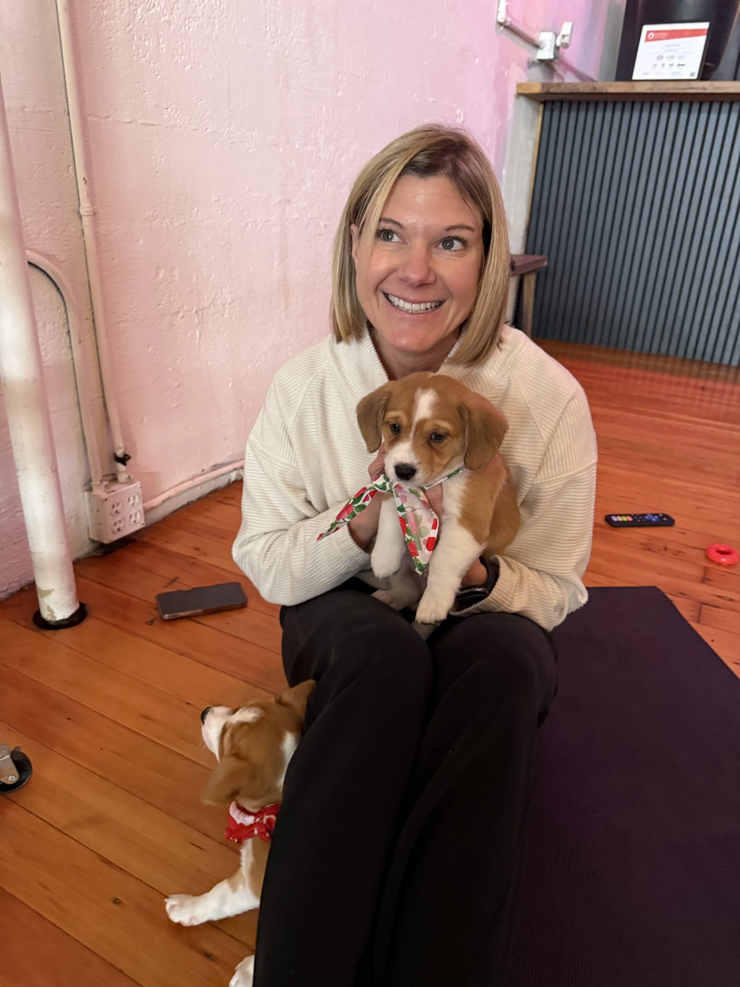 Smiling puppies and Rhonda Riley at a client appreciation event in Portland, OR