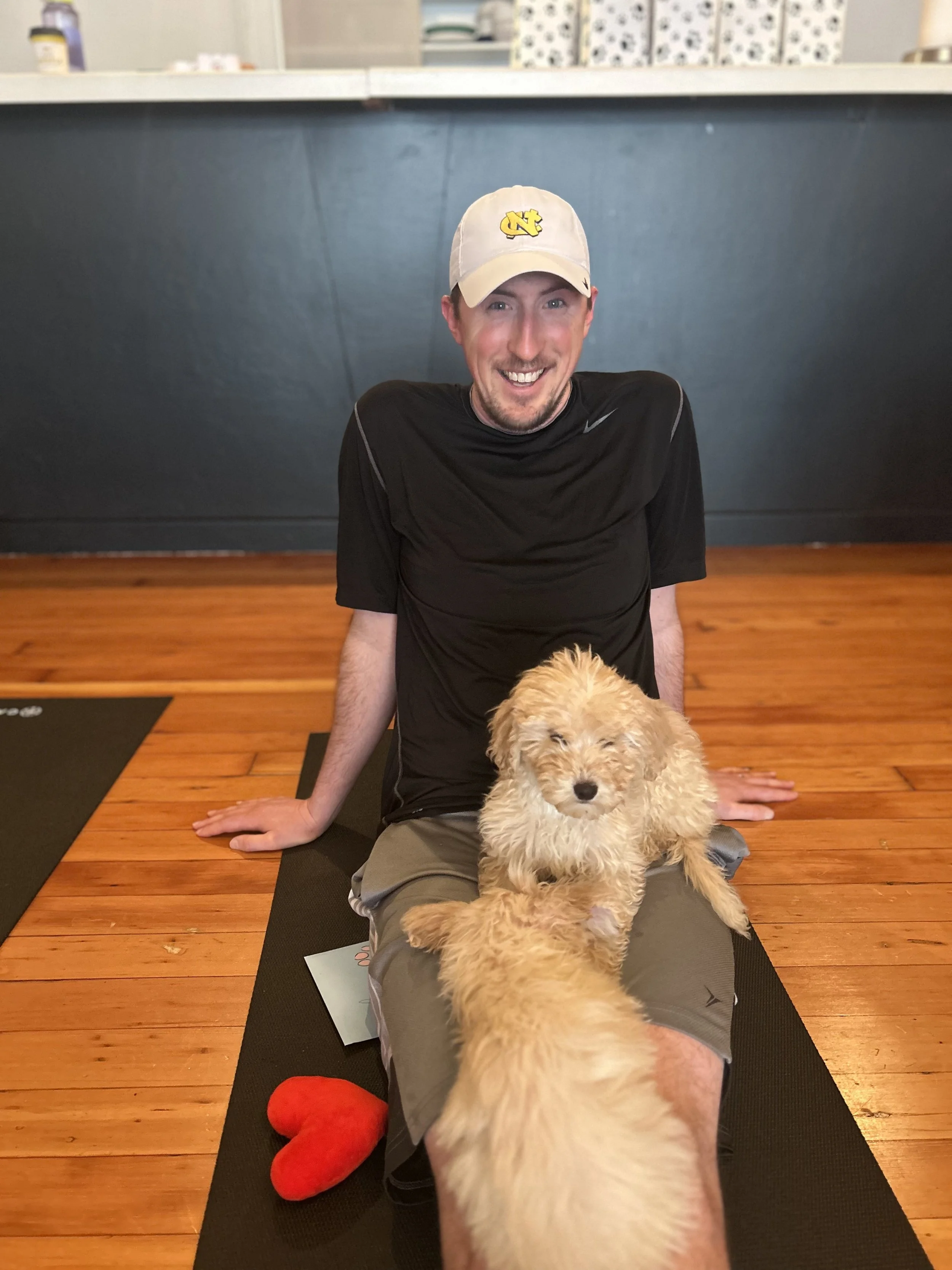 Friend and clientsposing with puppies at the Puppy Yoga 2025 VIP event in Portland, OR