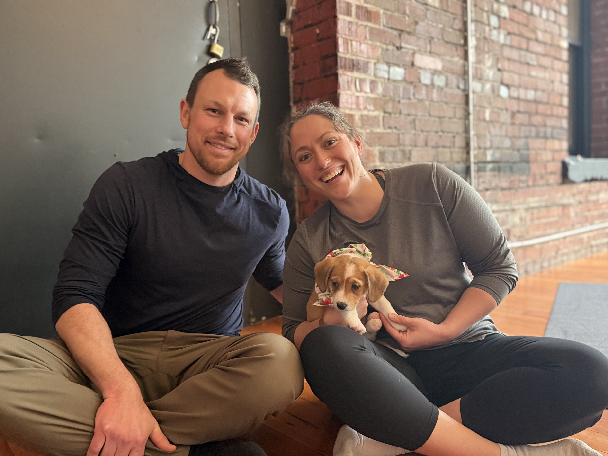 Friends and clients playing with puppies at the 2026 VIP Puppy Yoga event in Portland, OR