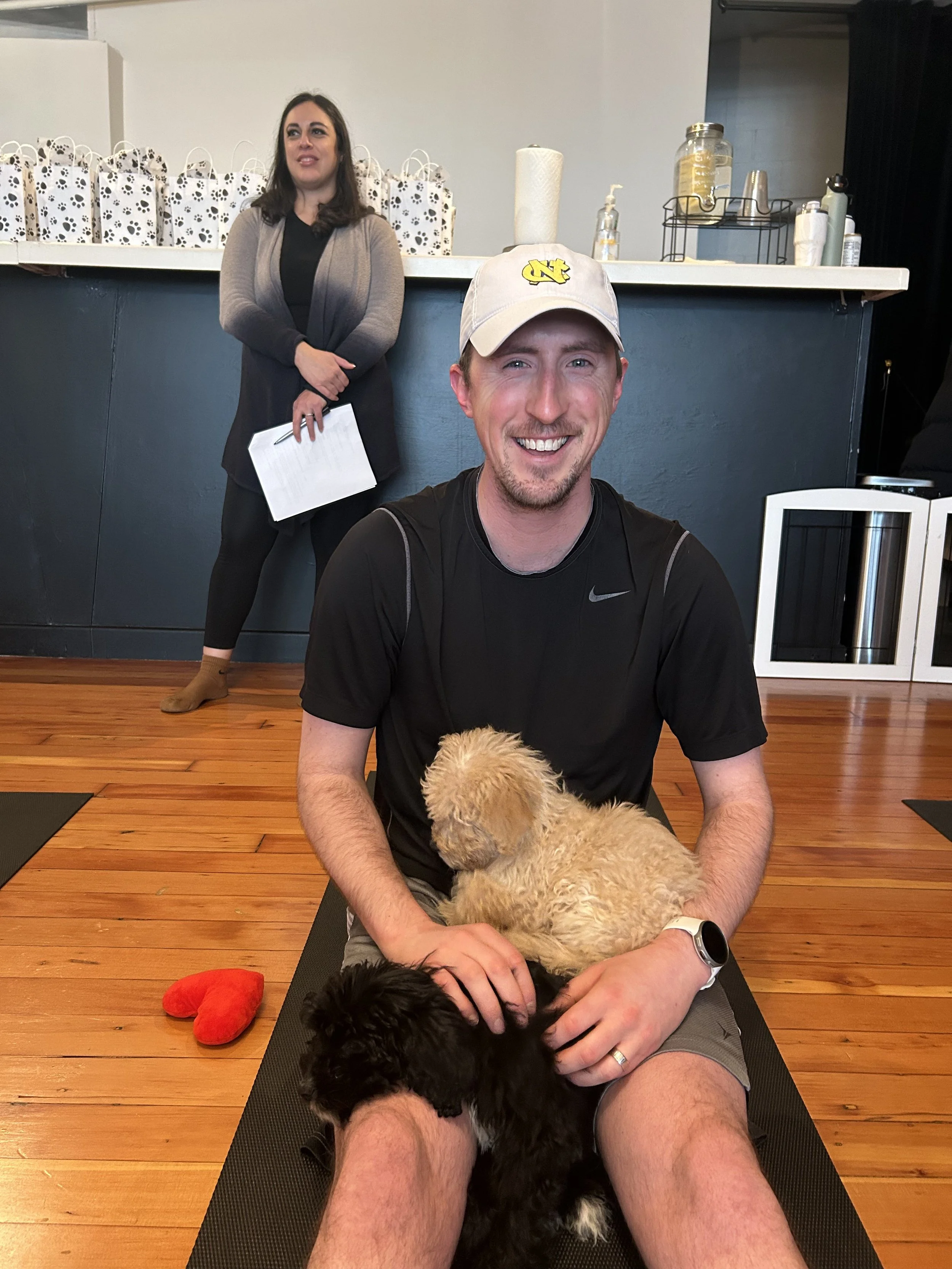 VIP clients laughing and playing with puppies during Puppy Yoga 2025 in Portland, OR