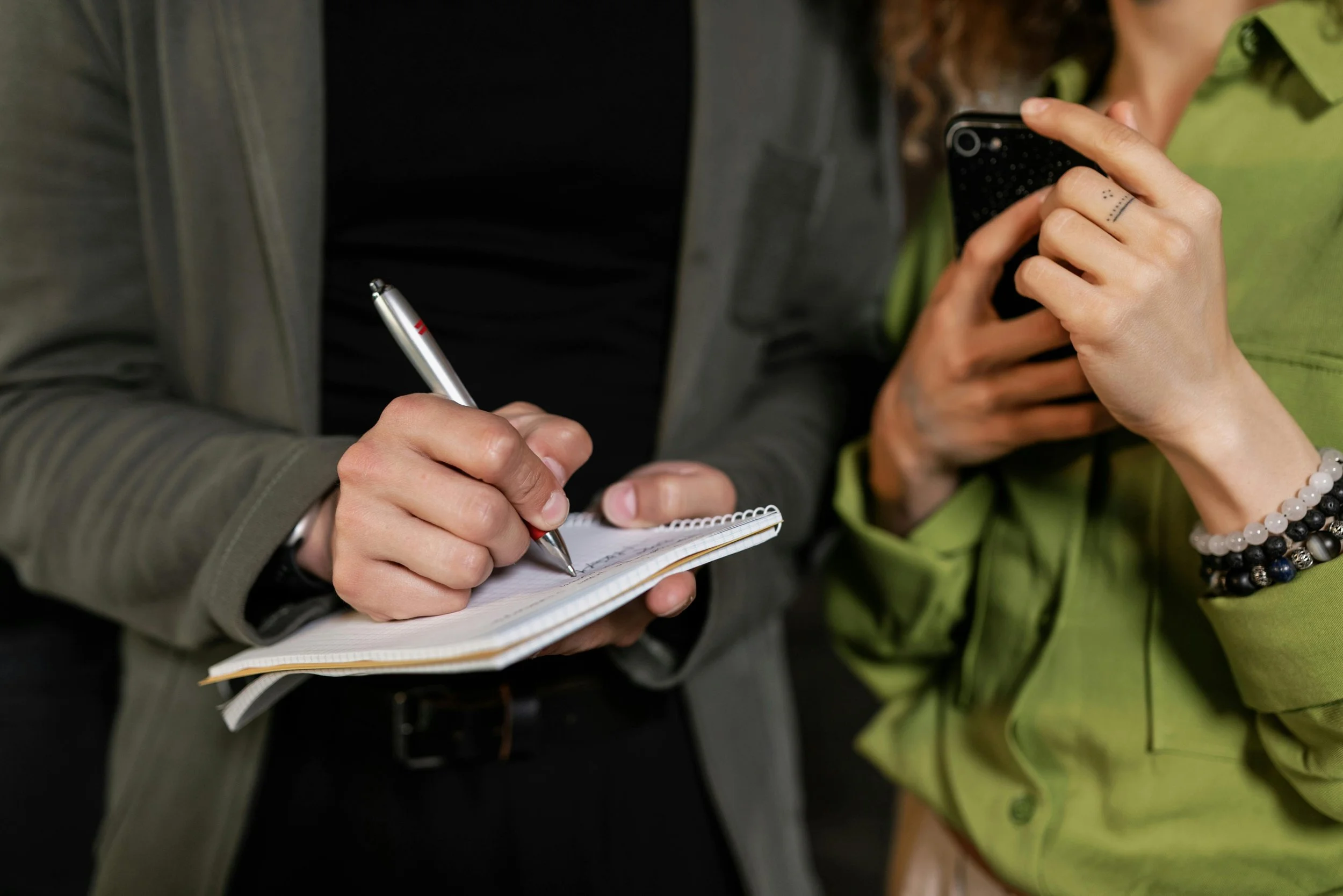 Close up of a real estate professional taking notes during a consultation with a homeowner in Forest Grove, Oregon.
