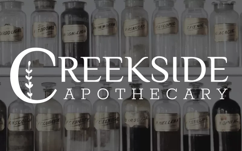 Glass bottles labeled with various chemicals in an apothecary storage area, with 'Creekside Apothecary' overlay text.