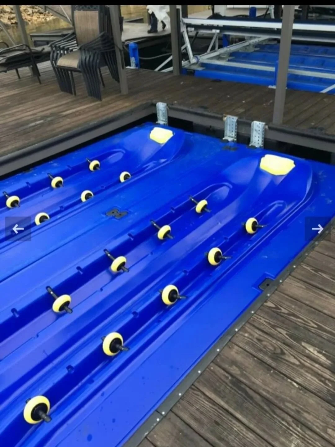 Floating Jet ski dock surrounded by wooden dock.