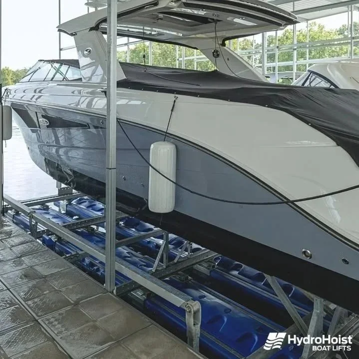 A  yacht inside a boat showroom on HydroHoist boat lift system.
