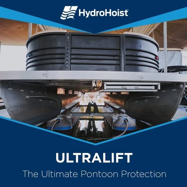 A HydroHoist Ultralift pontoon boat lift with a pontoon boat on it, under a shelter, showcasing the boat protection system.