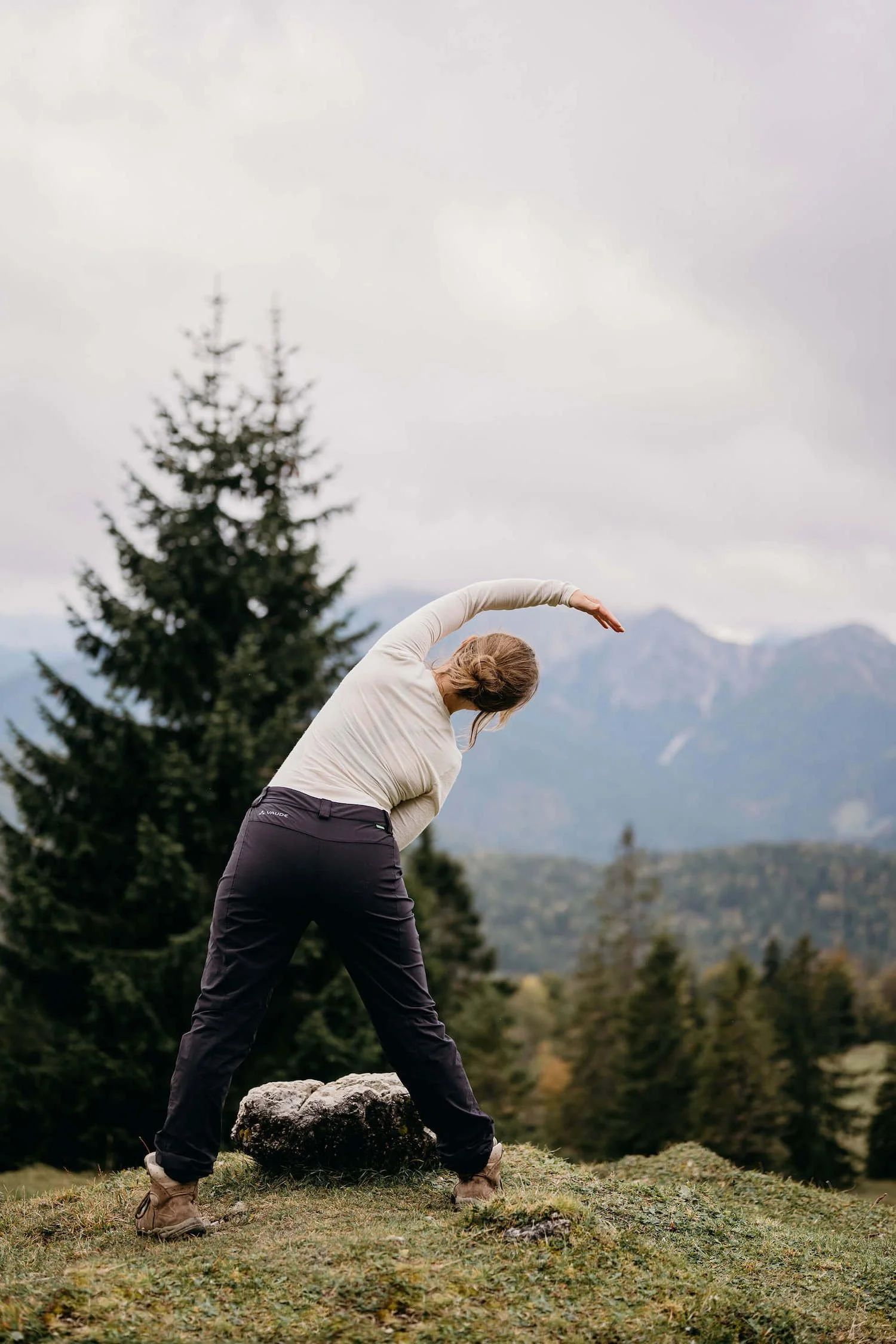 menopausal woman in nature doing yoga