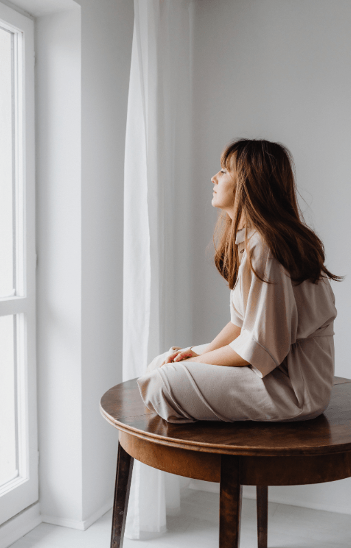 Woman discouraged looking out window