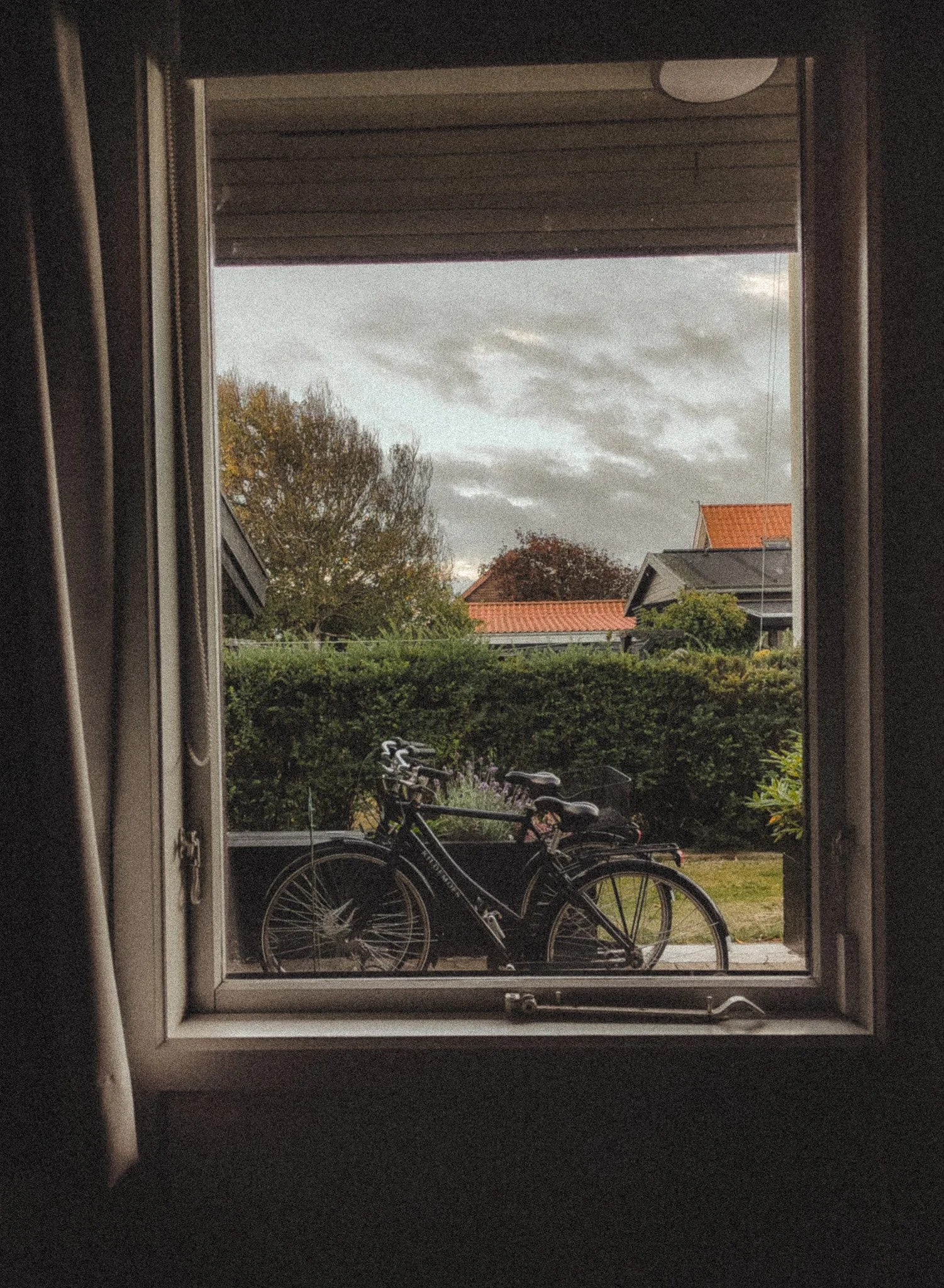 A view of two bicycles through the window in Skagen Denmark.