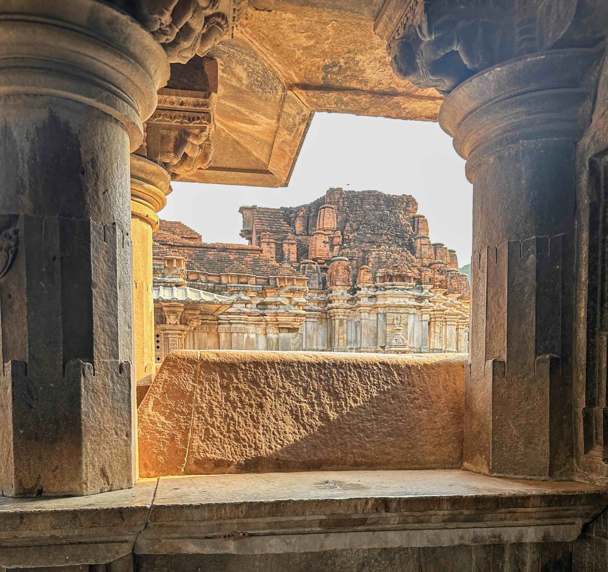 Ancient carved sandstone columns and towers at Chittorgarh Fort, Rajasthan - India with Bernadette