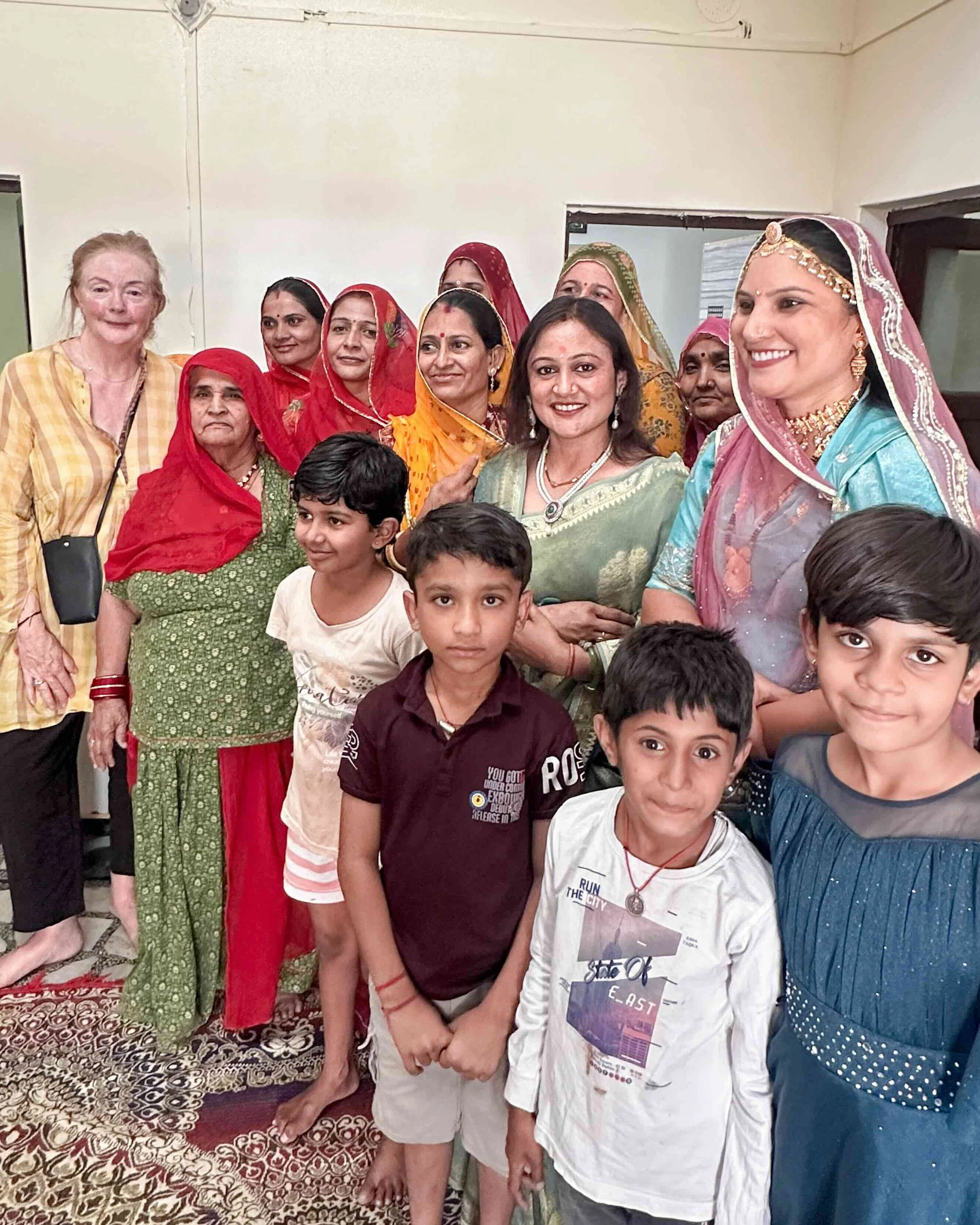 Bernadette O’Farrell with Ruma Devi, her family and children gathered inside her home in Barmer, Rajasthan, during Diwali