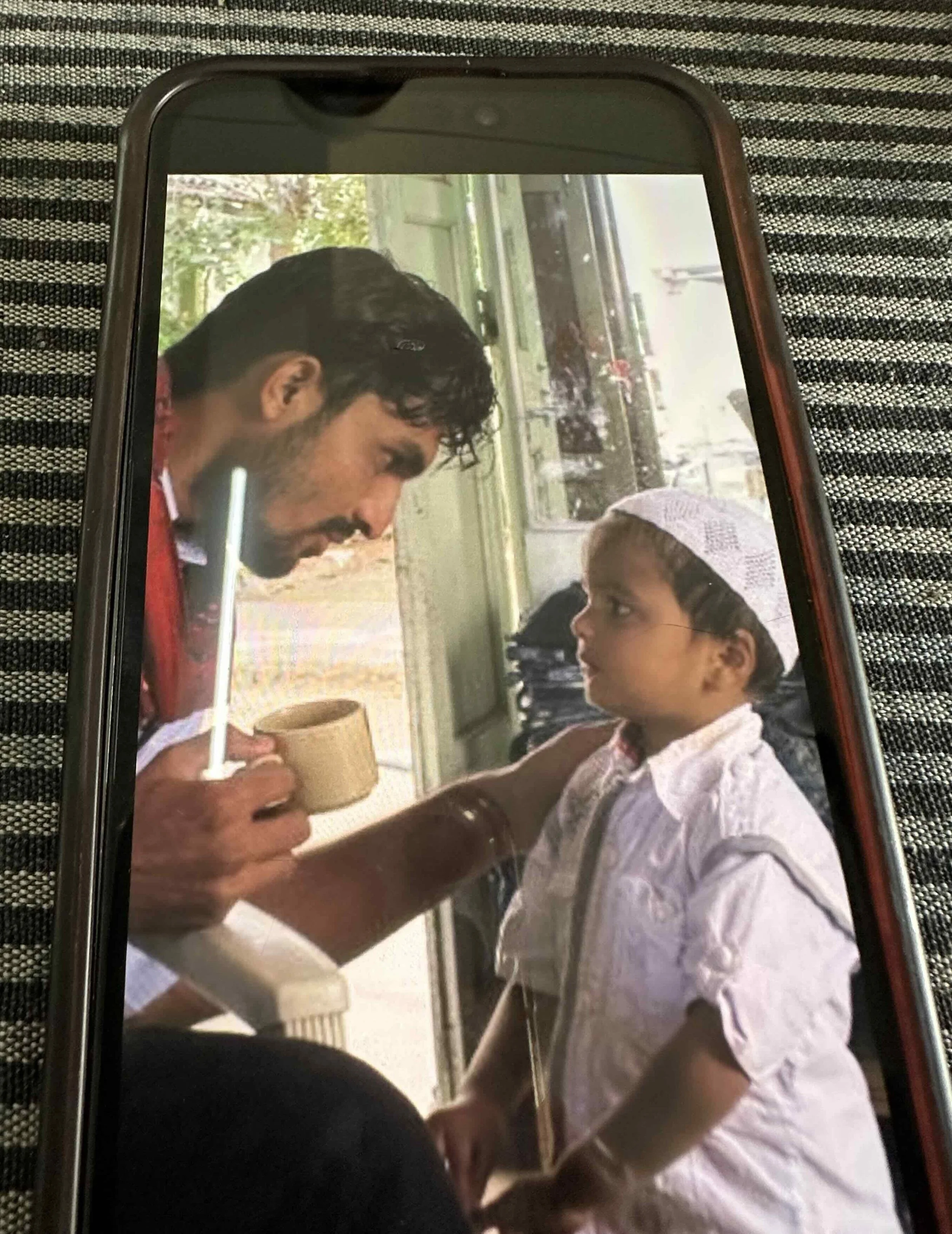 Faizan Khatri as a young boy with Kuldip Gadhvi at the ajrakh workshop in Ajrakhpur — a childhood photograph shown to the author during her visit.