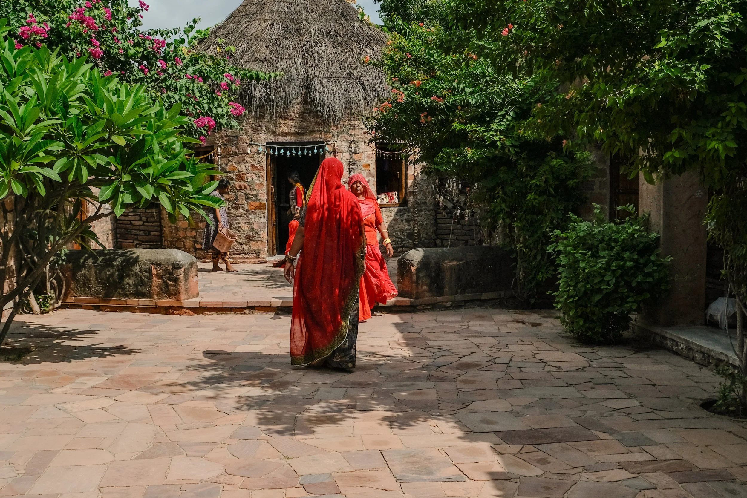 Women in red saris at Sunder Rang artisan collective, Chandelao, Rajasthan - India with Bernadette
