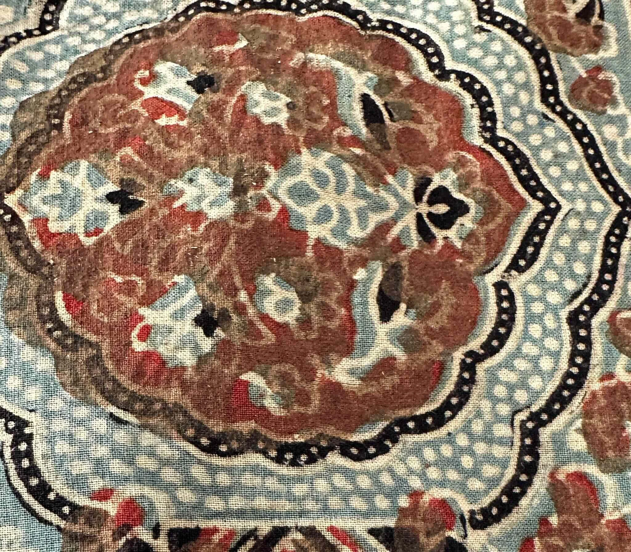 Ajrakh cloth mid-process at Khatri Sufiyan Ismail’s workshop in Ajrakhpur — natural dyes and resist printing building layer by layer, the piece not yet complete.