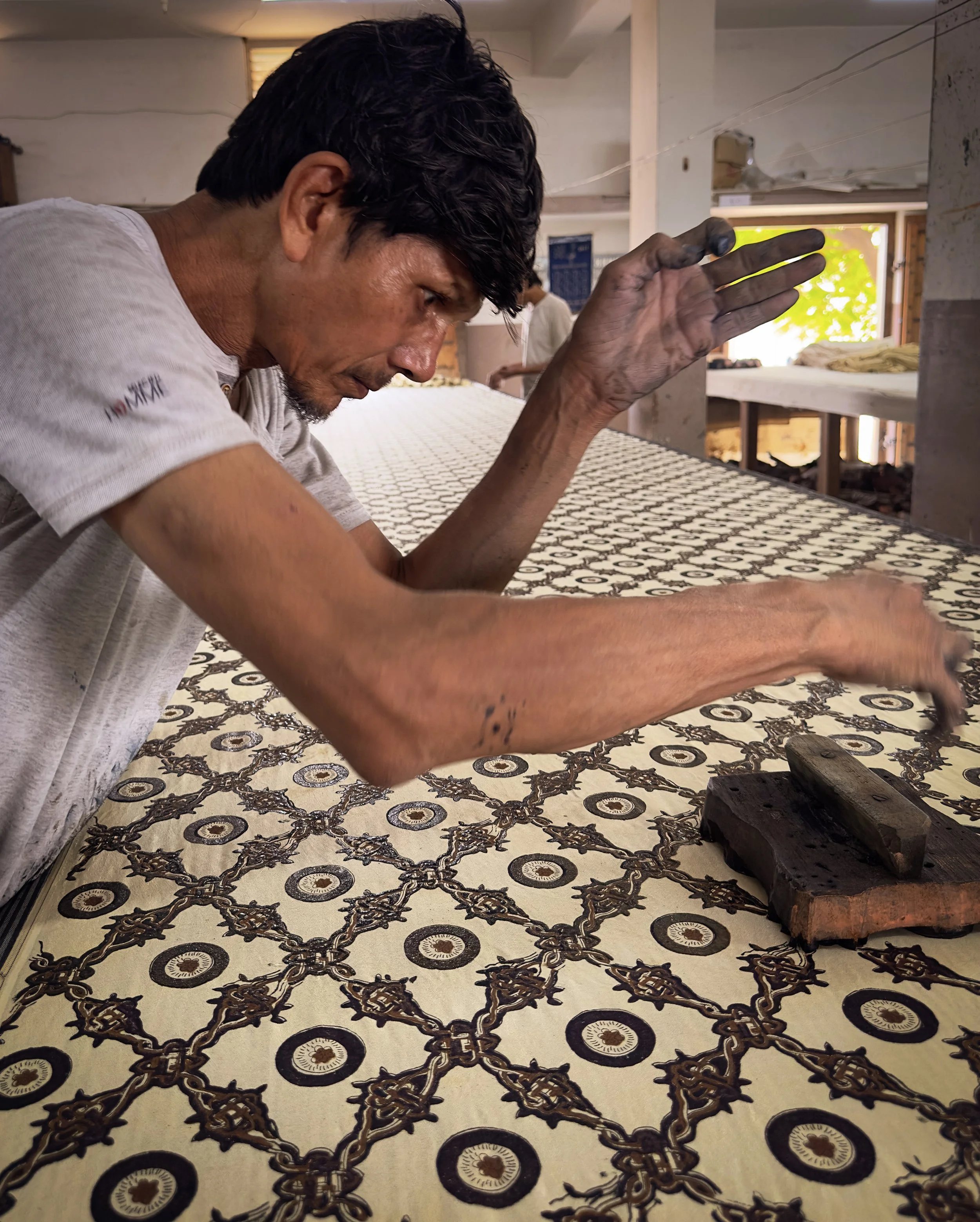 Khatri artisan hand block printing traditional Ajrakh fabric in Bhuj, Kutch, Gujarat