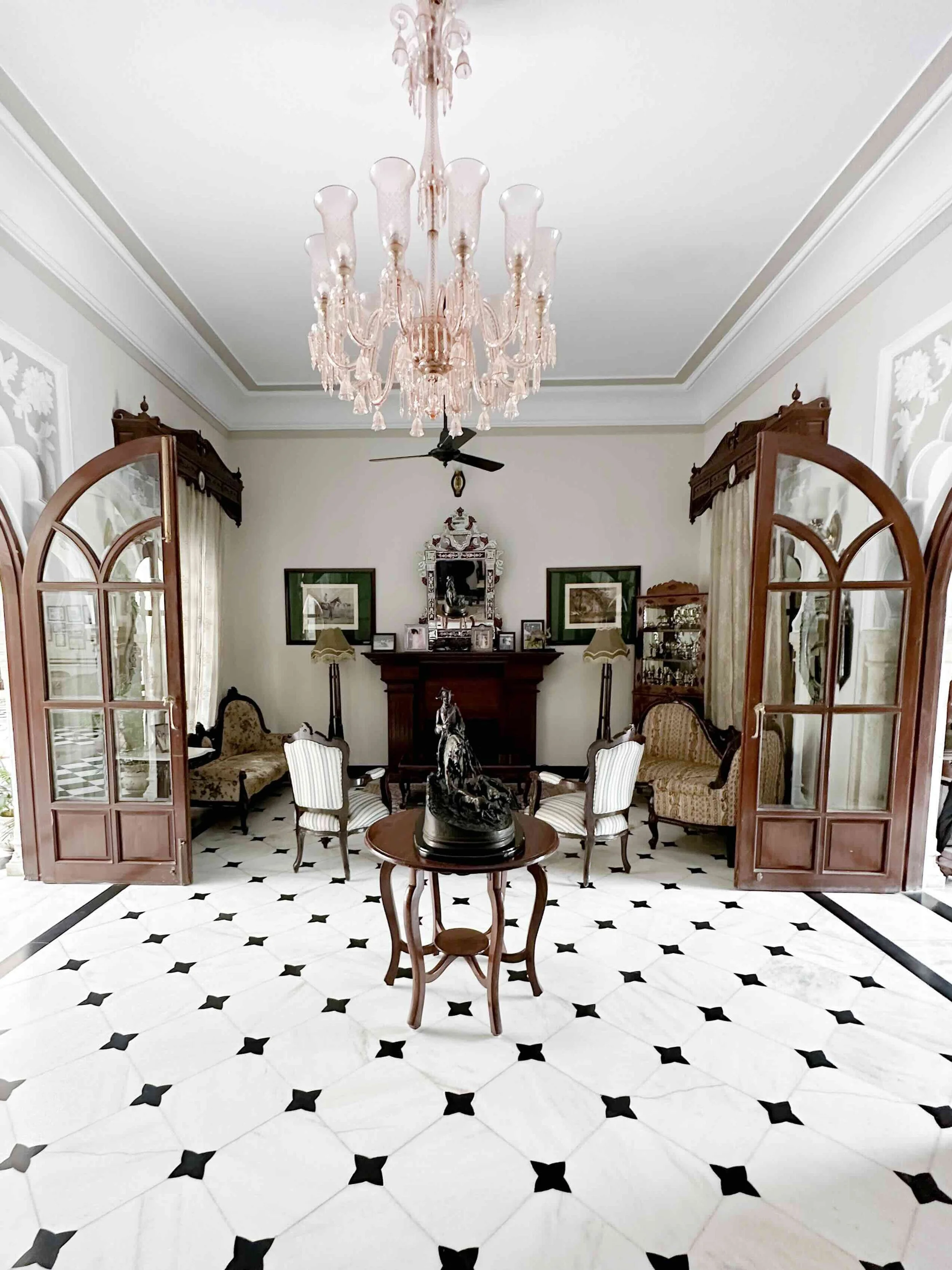 Chandelier and antique-furnished drawing room at Khas Bagh heritage hotel, Aravalli Hills, Rajasthan - India with Bernadette
